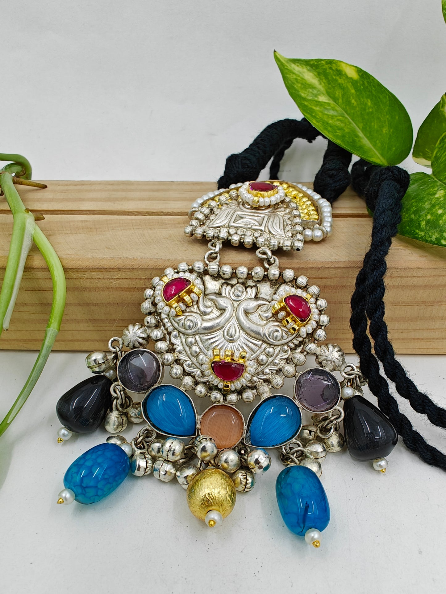 Tilism necklace in black thread with a dual tone pendant with multicolour big stones,kundan,pearl work and ghungroo