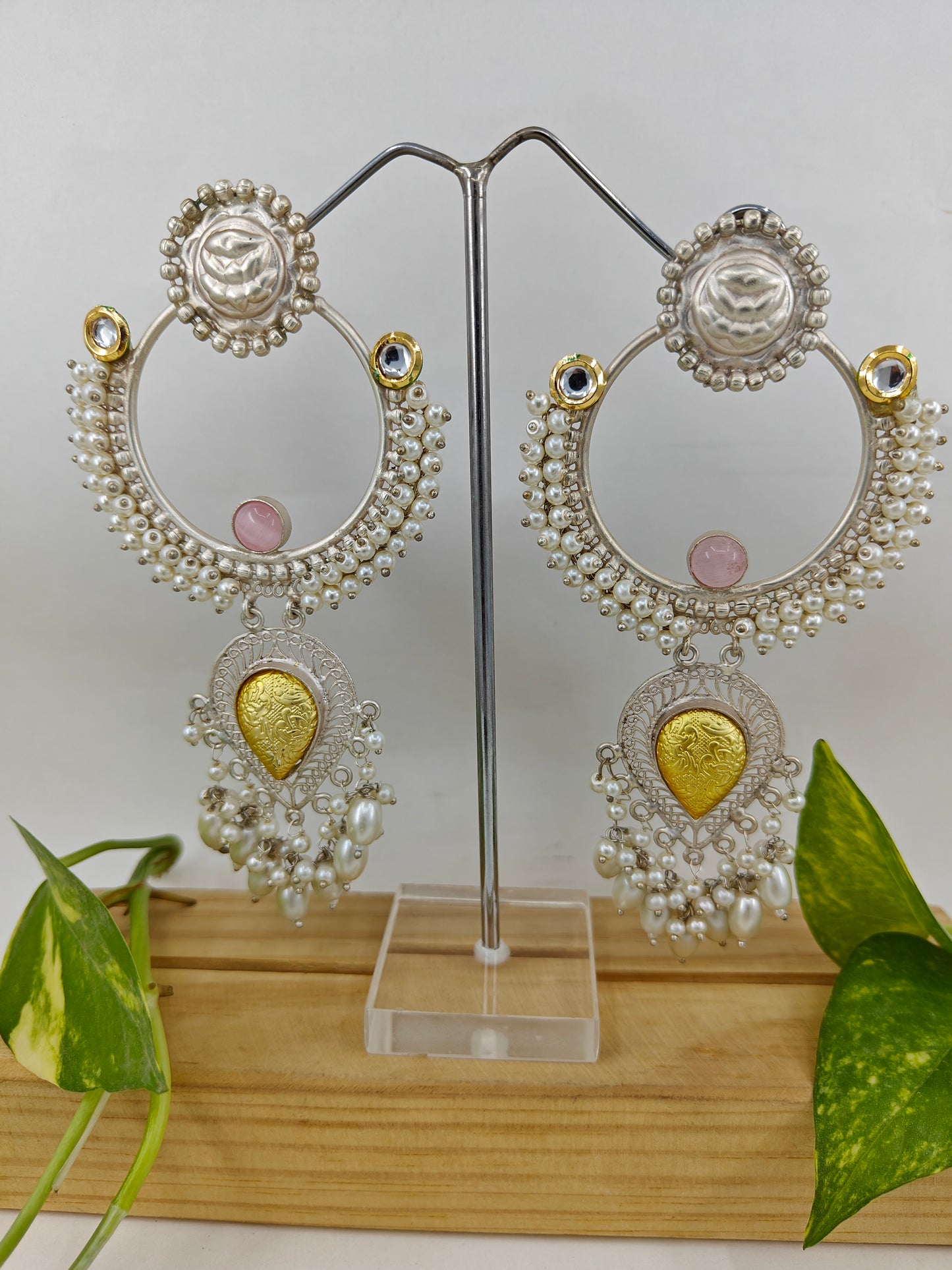 Earrings with a big ring design with pearls,and a dual tone hanging below