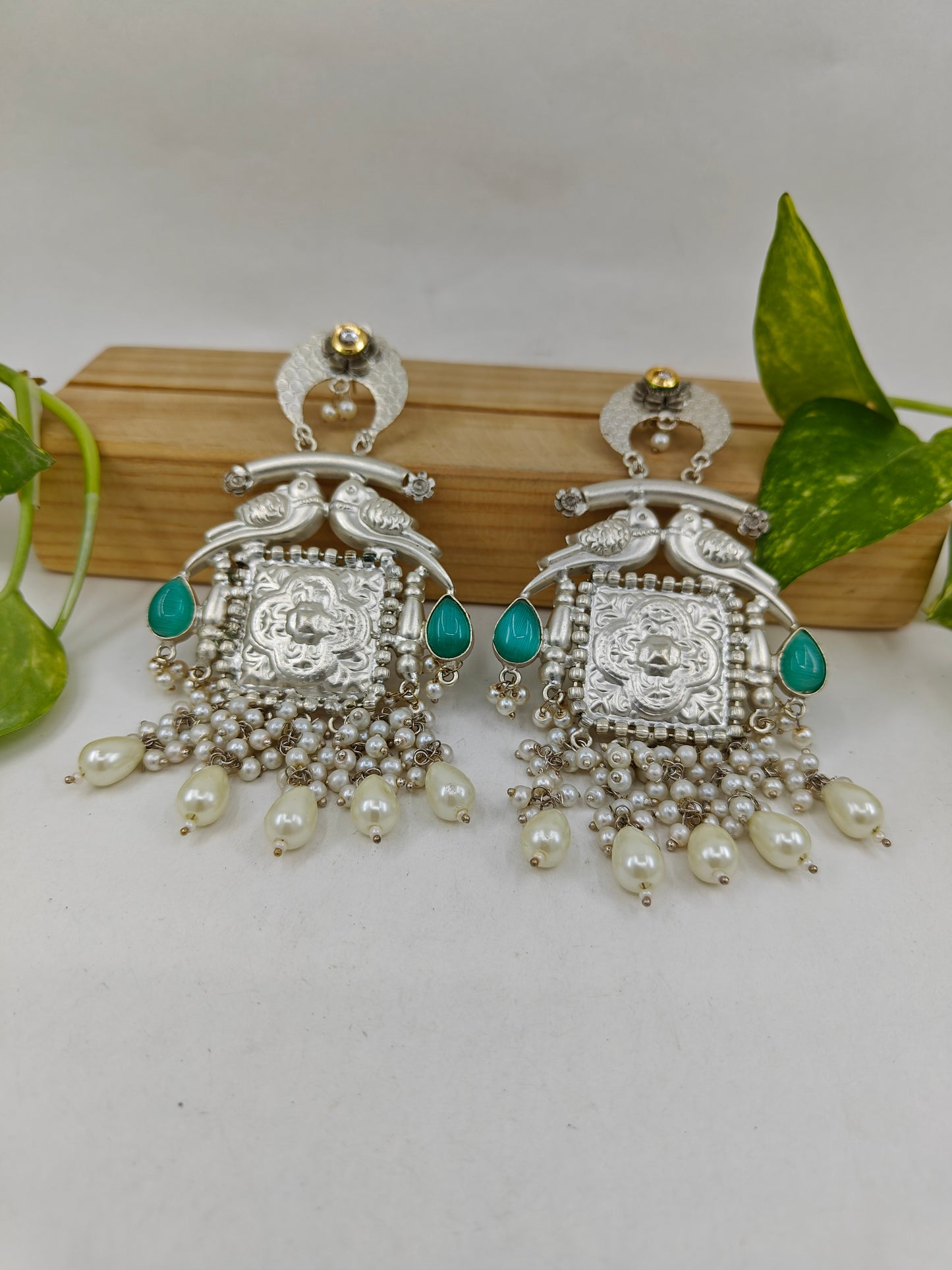 Big earrings with carvings in silver finish with sea green stone highlights