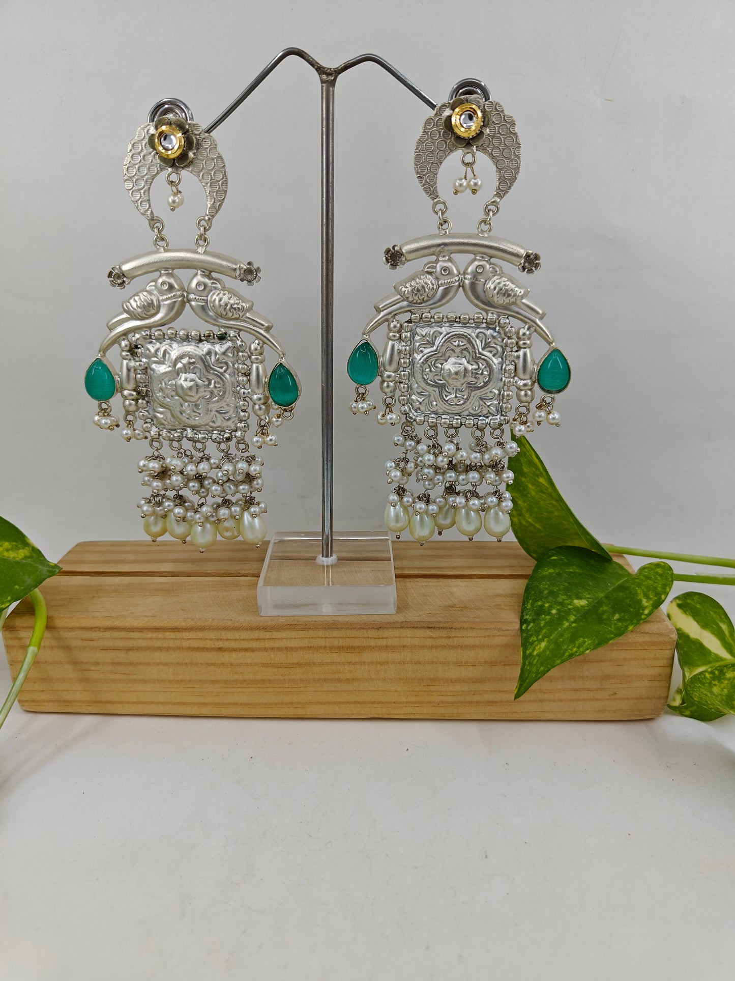 Big earrings with carvings in silver finish with sea green stone highlights