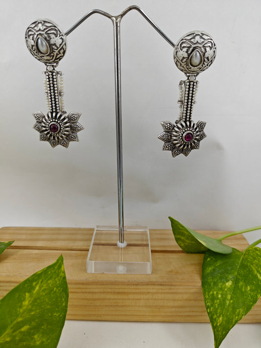 Earrings with carvings with a stud with pearl and hanging flower design