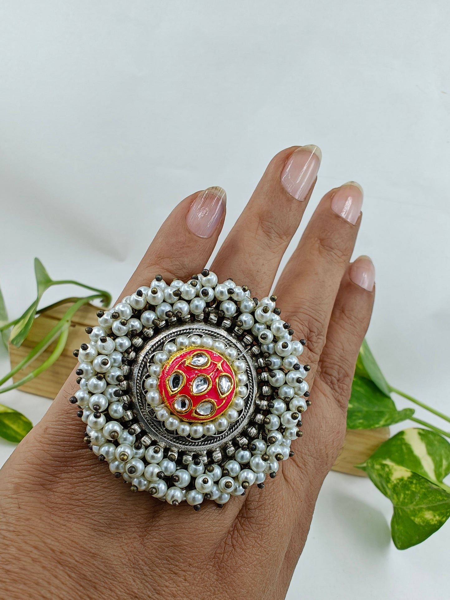 Ring with kundan and meenakari work in centre,pearl beads surrounding it