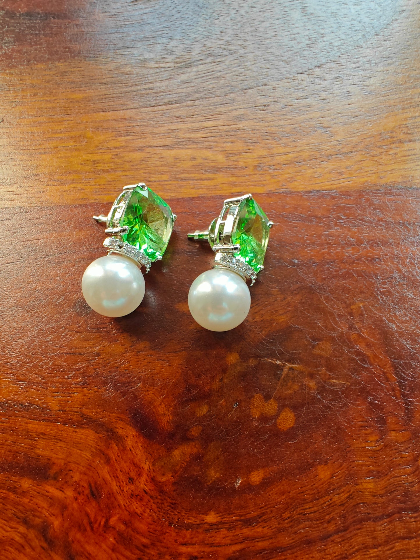 Platinum finish studs with square stone and a big pearl at the bottom