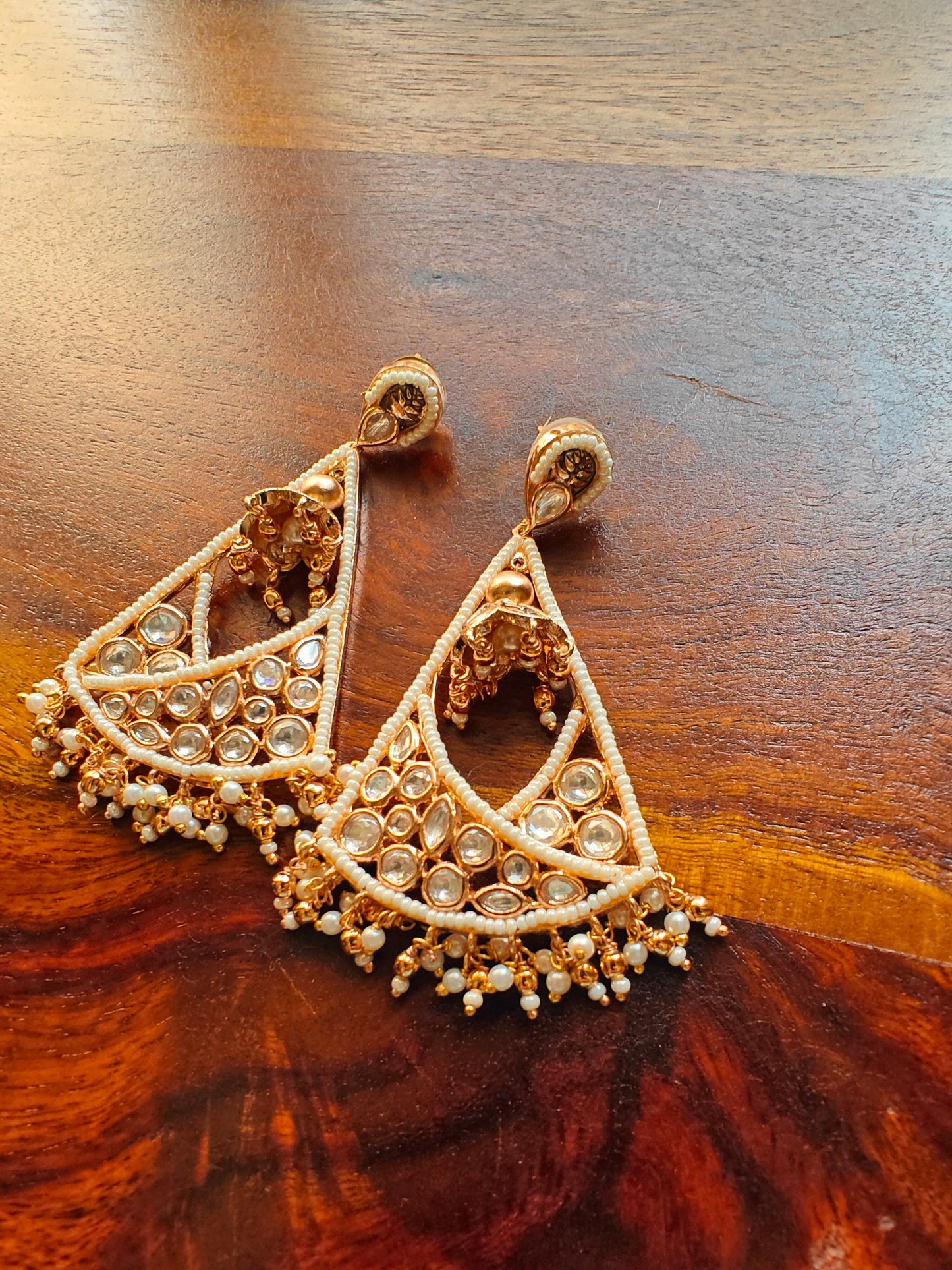 Poth pearl and Kundan triangular hanging earrings.