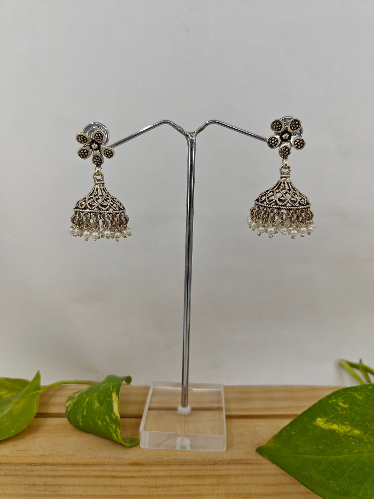 Silver jali jhumkis (earrings) on an open flower stud,pearl hangings