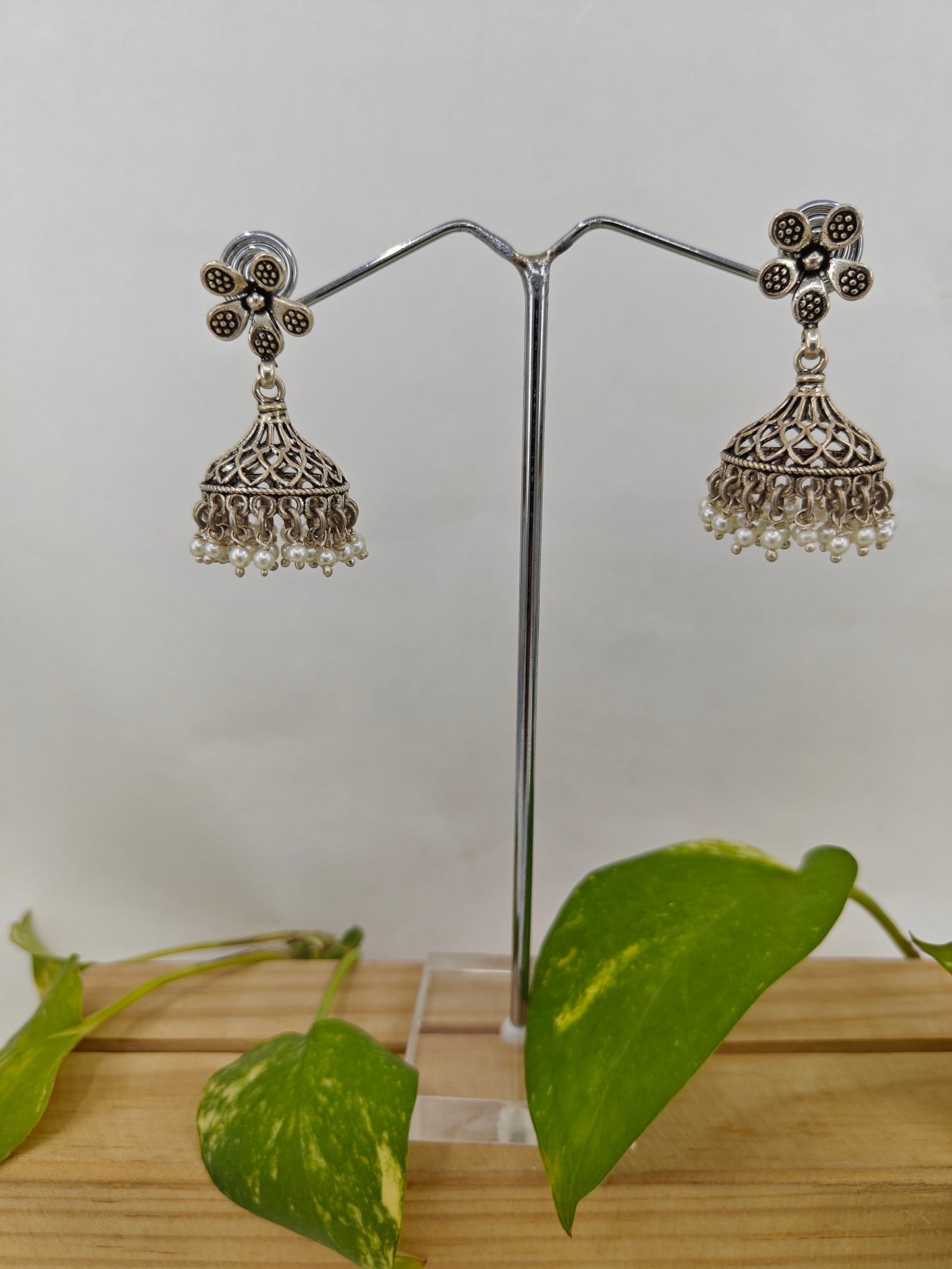 Silver jali jhumkis (earrings) on an open flower stud,pearl hangings