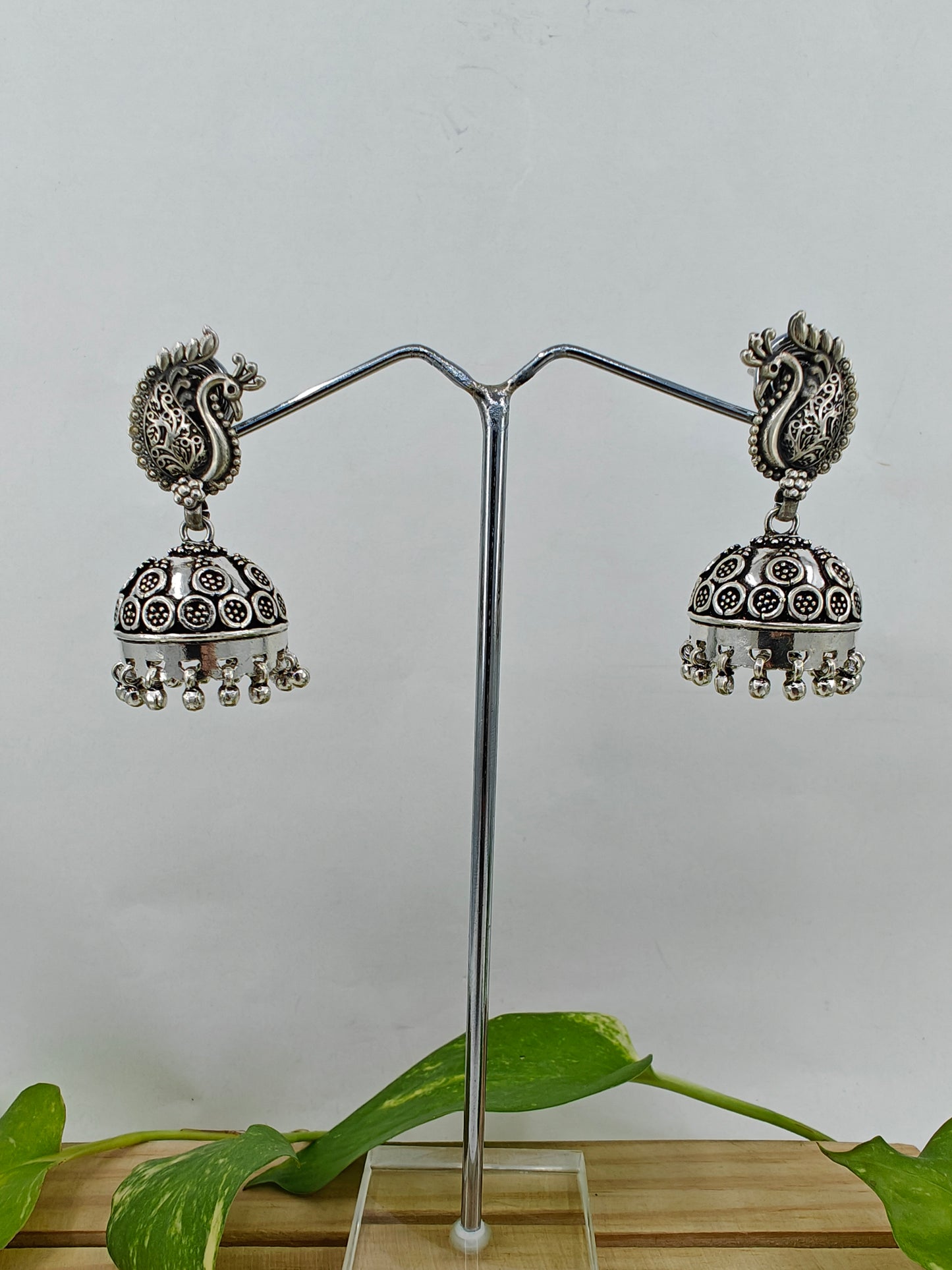 Silver jhumkas (earrings) on peacock stud, hanging ghungroos at the bottom