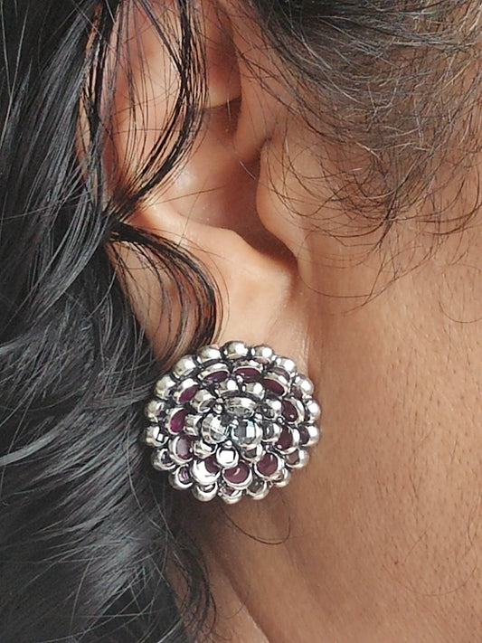 Silver stud earrings in an concentric petals floral design