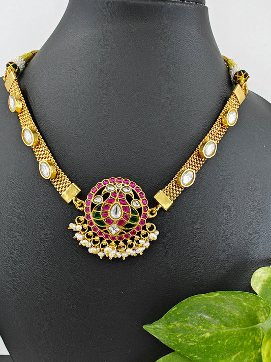 Necklace in gold finish with red and green Kemp stone inlay in peacock motif