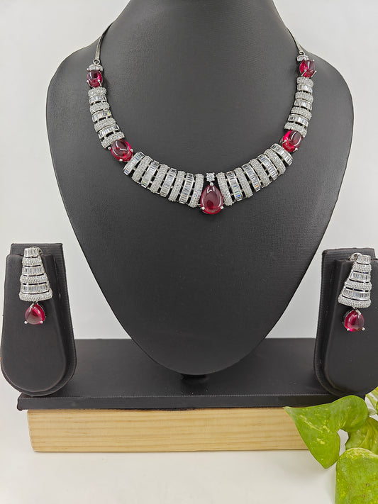 Set in platinum finish with CZ in alternate bands and ruby red stones.Comes with 2 pairs of earrings