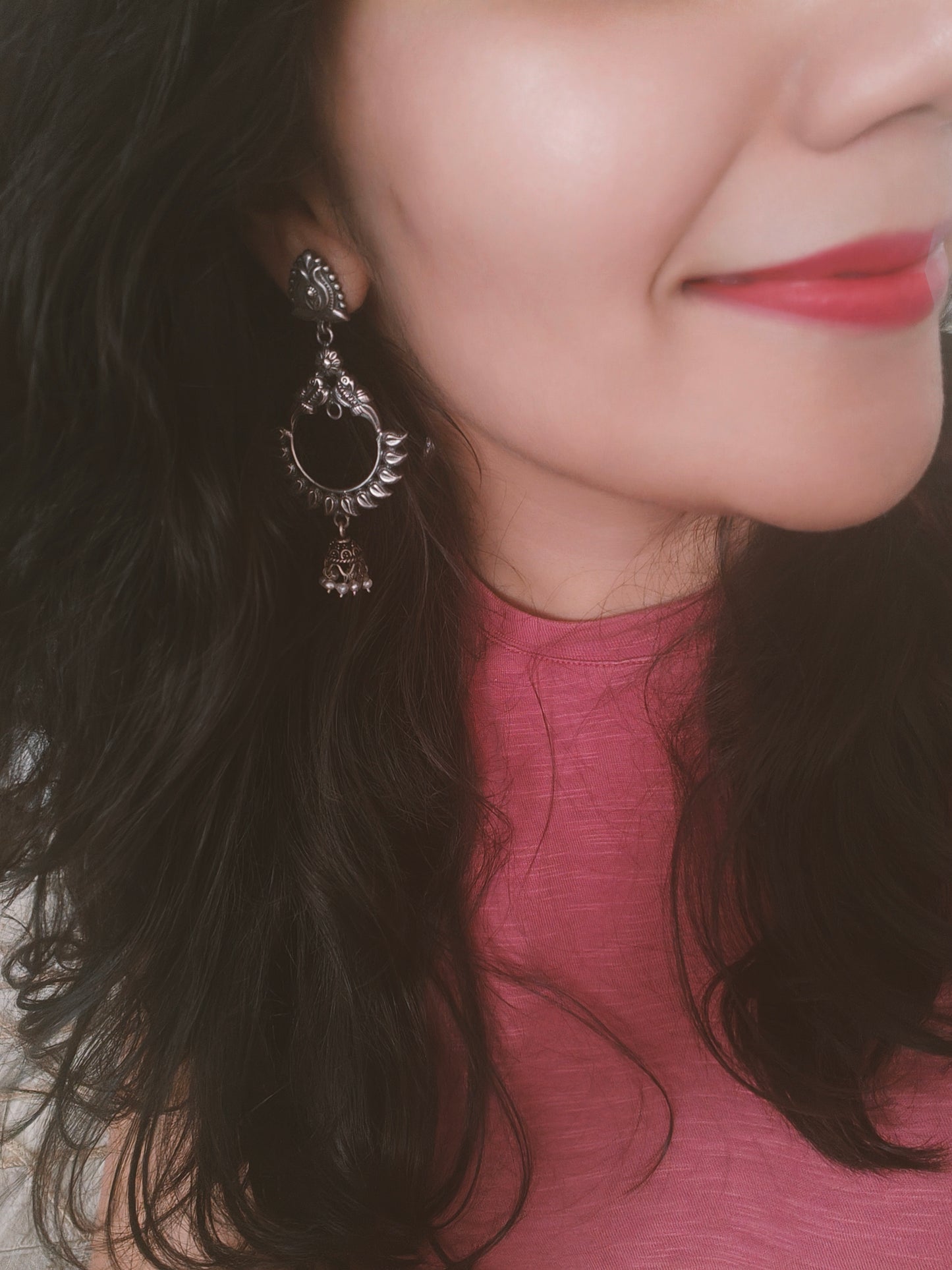 Peacock motif circular silver earrings with a hanging bali