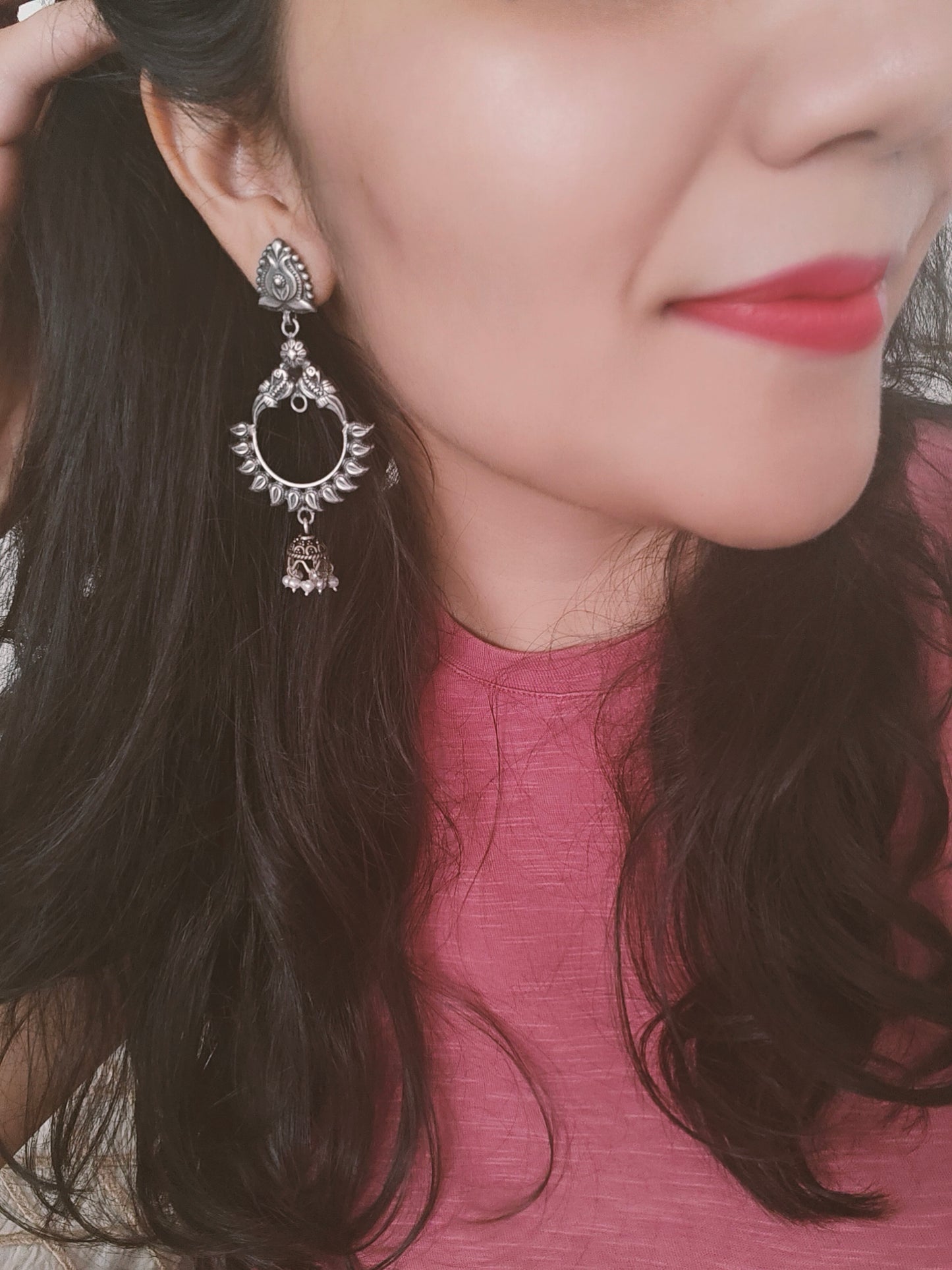 Peacock motif circular silver earrings with a hanging bali