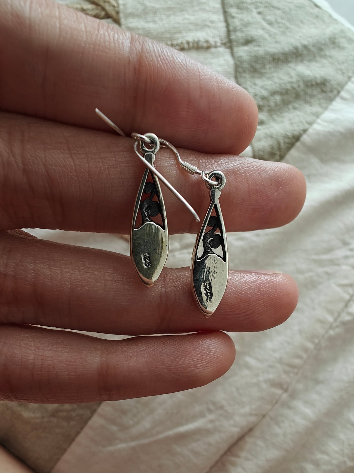 Elliptical silver earrings with carvings and pastel coloured stones