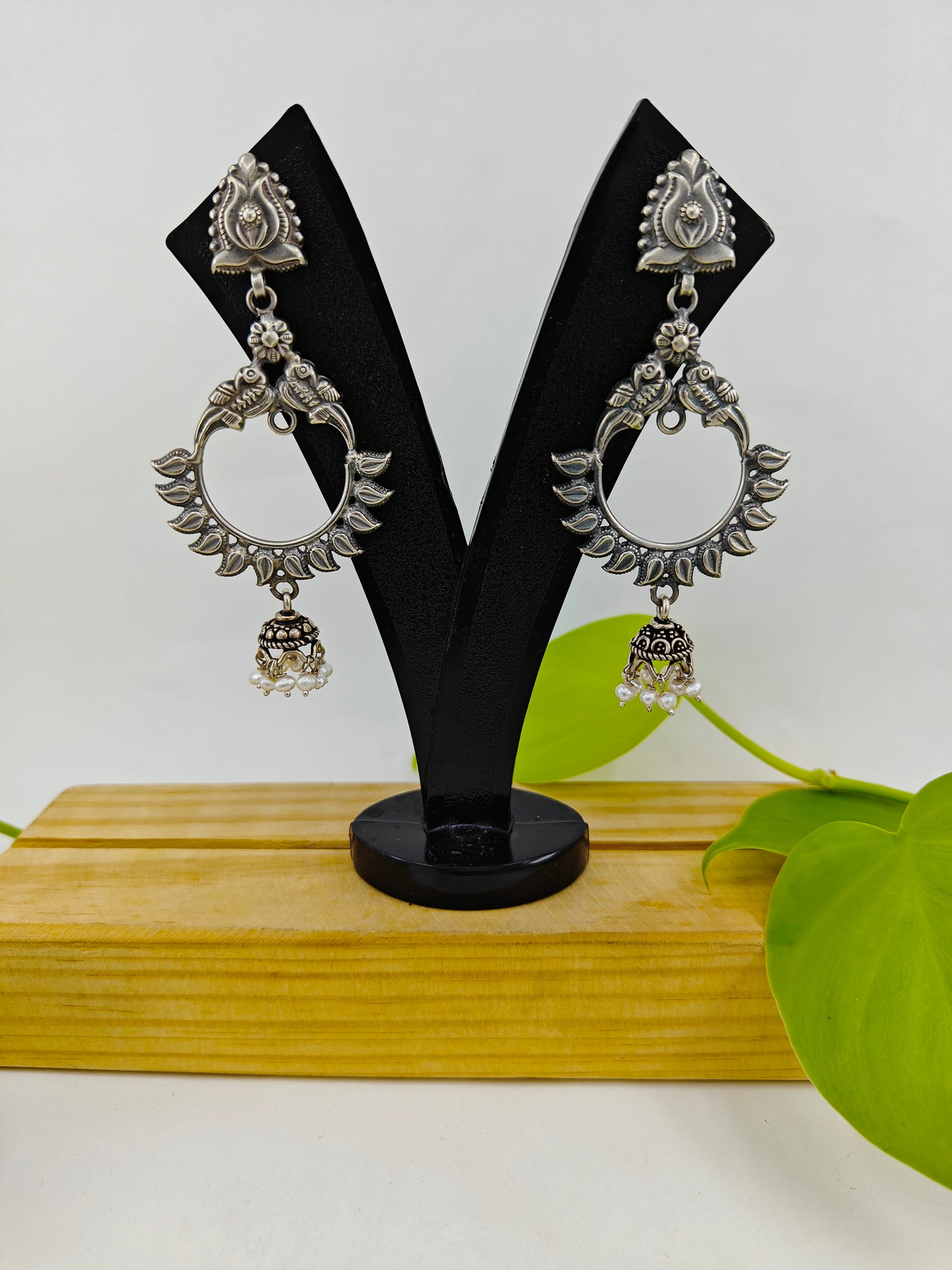 Peacock motif circular silver earrings with a hanging bali