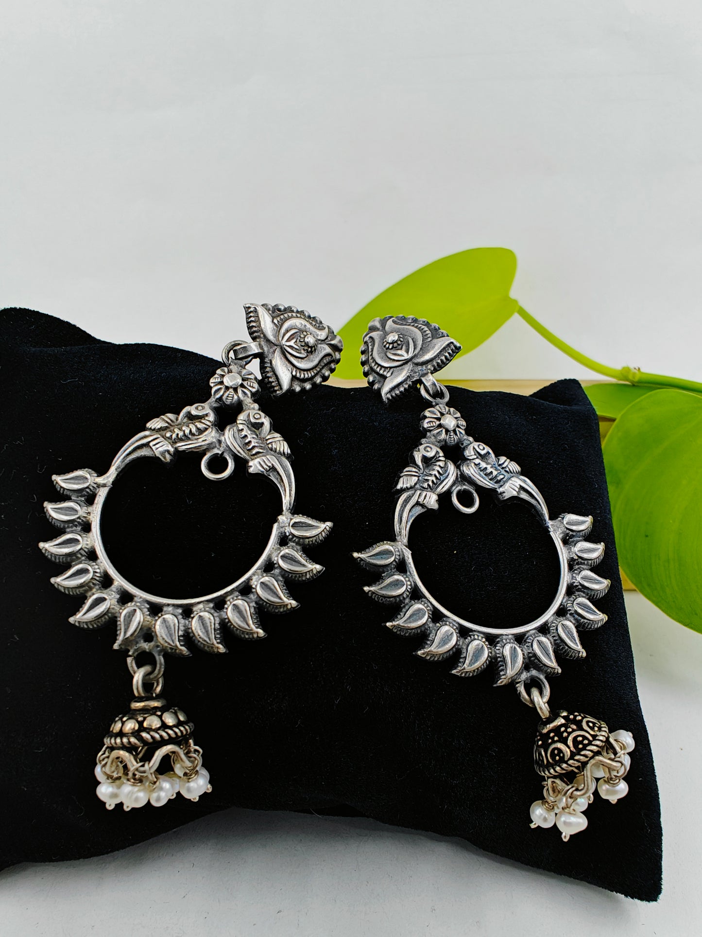 Peacock motif circular silver earrings with a hanging bali