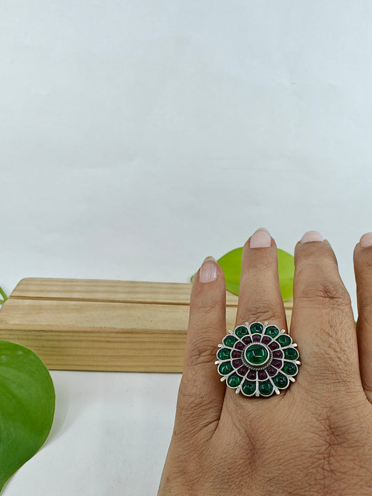 Silver ring in flower design with green and red stone inlay