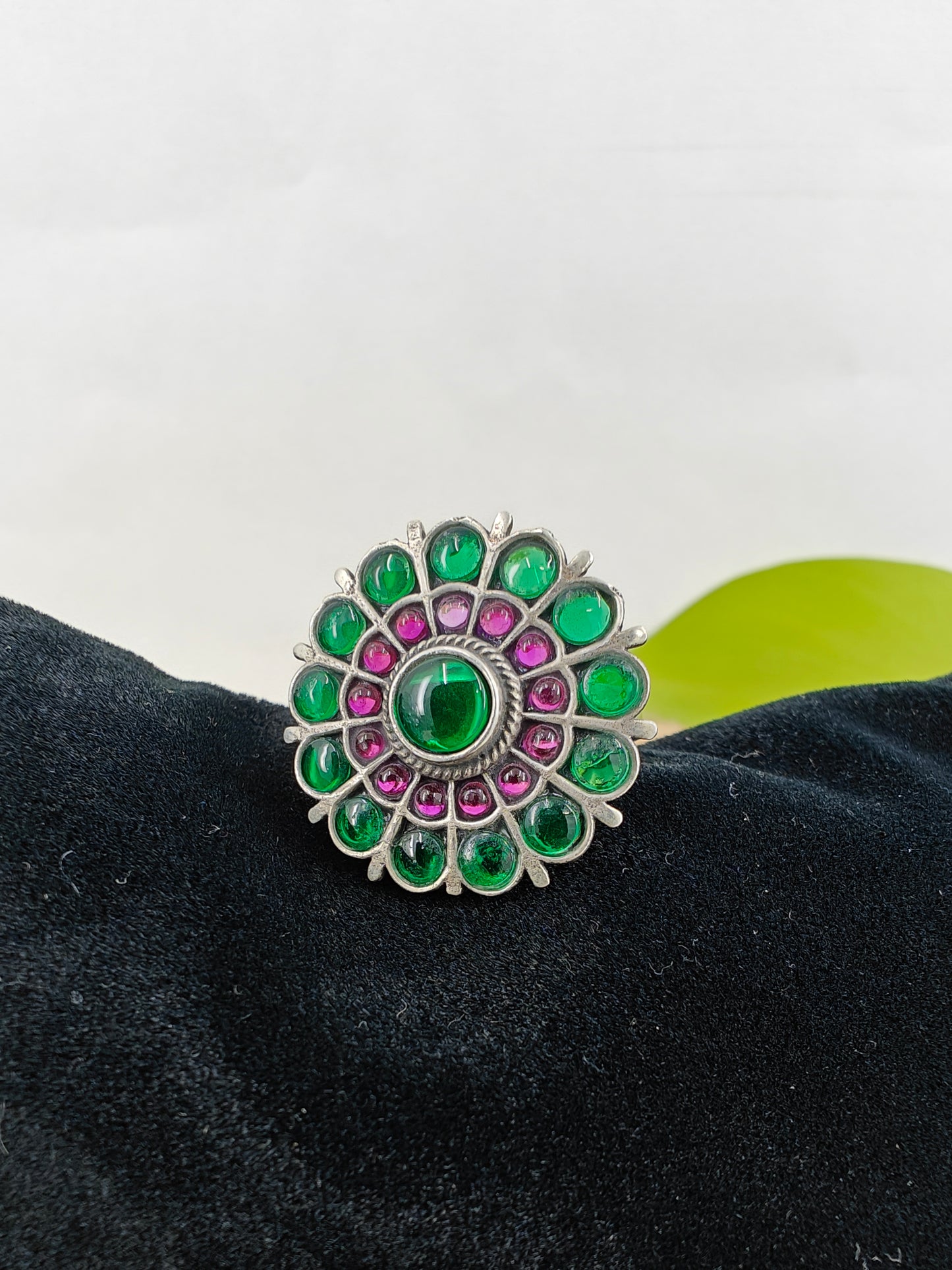 Silver ring in flower design with green and red stone inlay