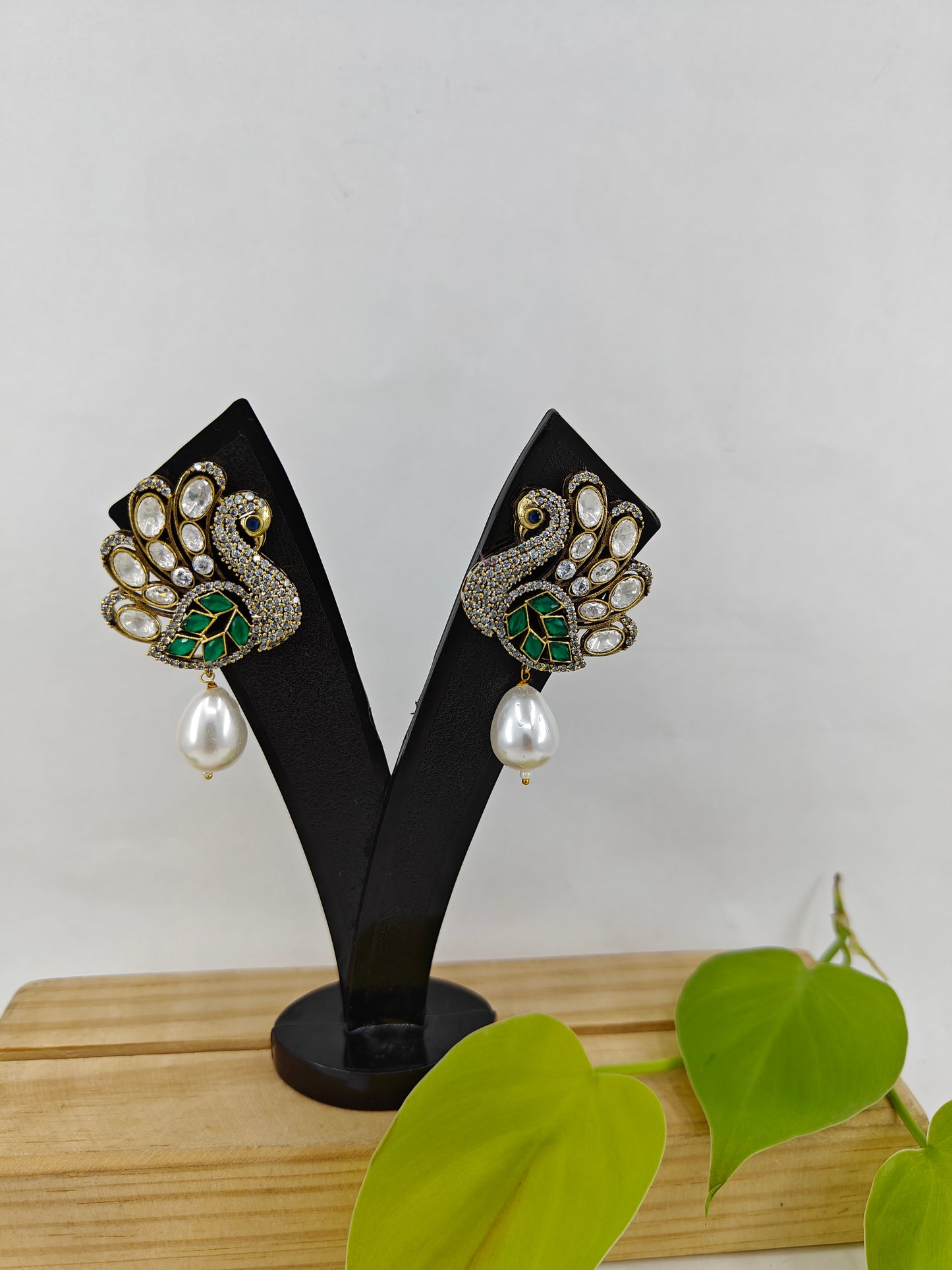 Peacock stud earrings with kundan studded 'feathers' and a pearl drop