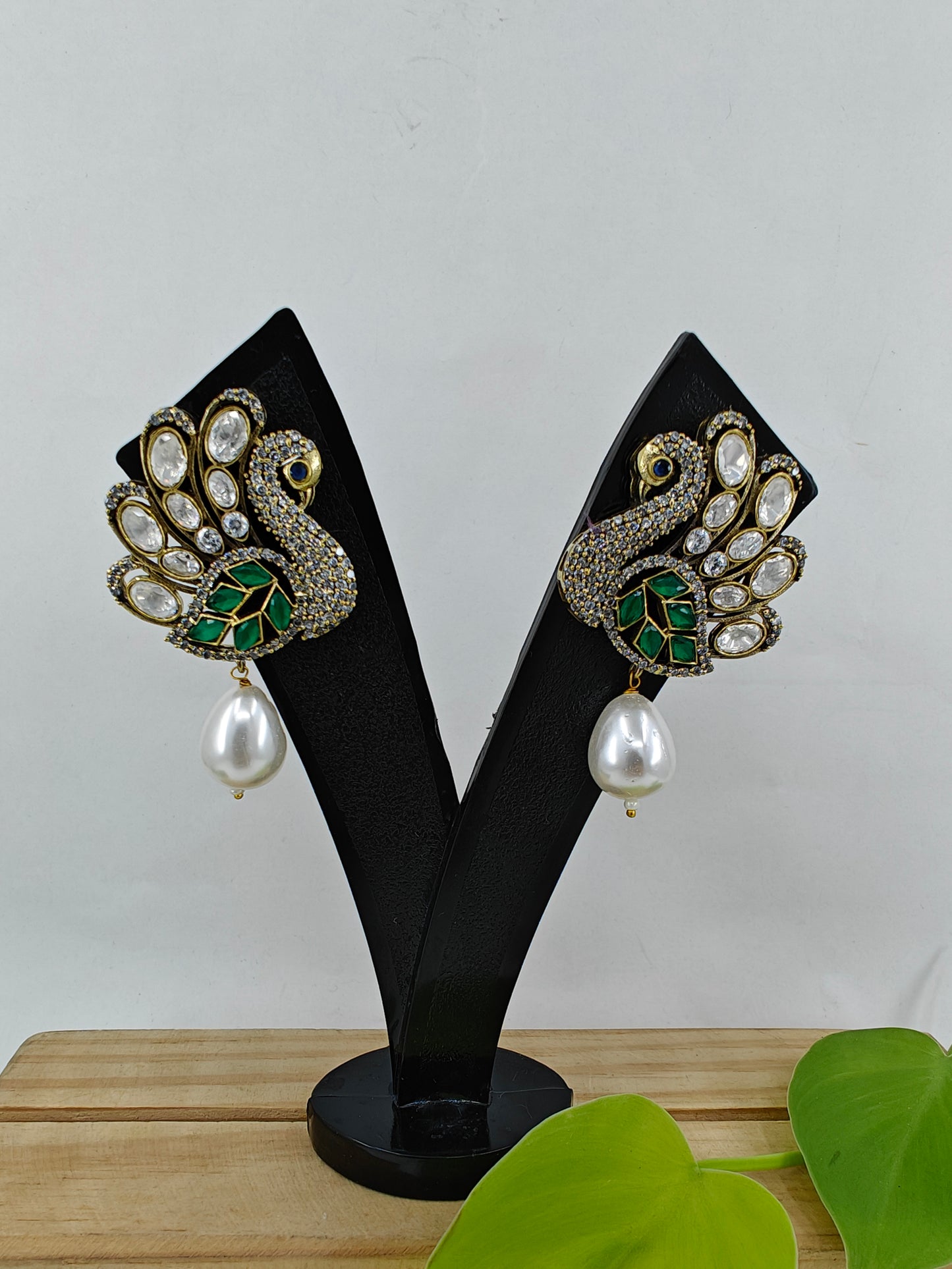 Peacock stud earrings with kundan studded 'feathers' and a pearl drop