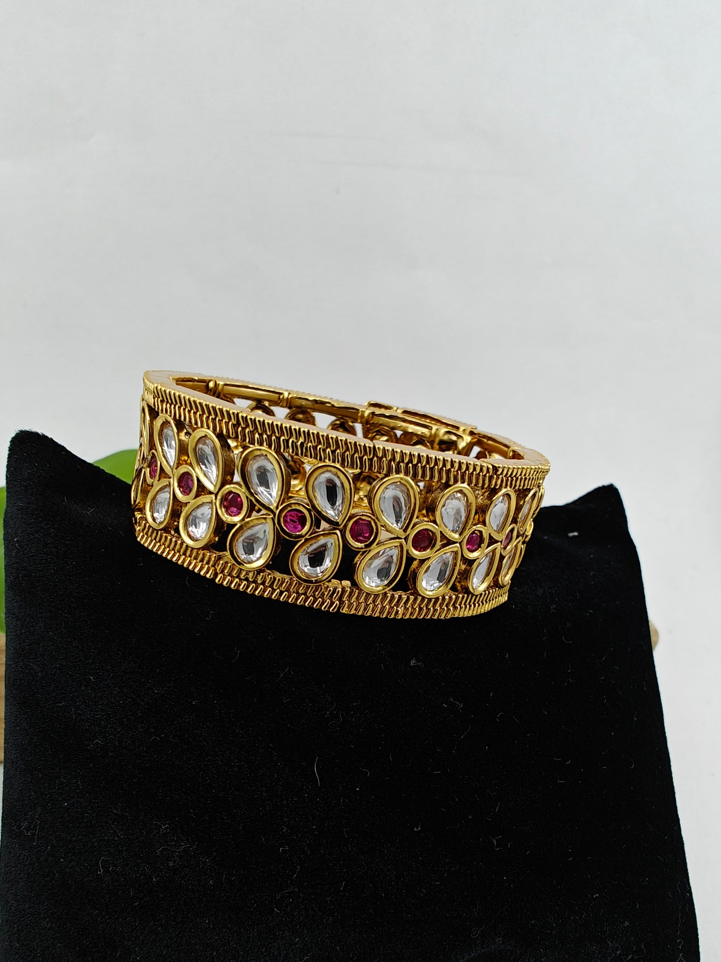 Gold finish kundan cuff with snap shut design