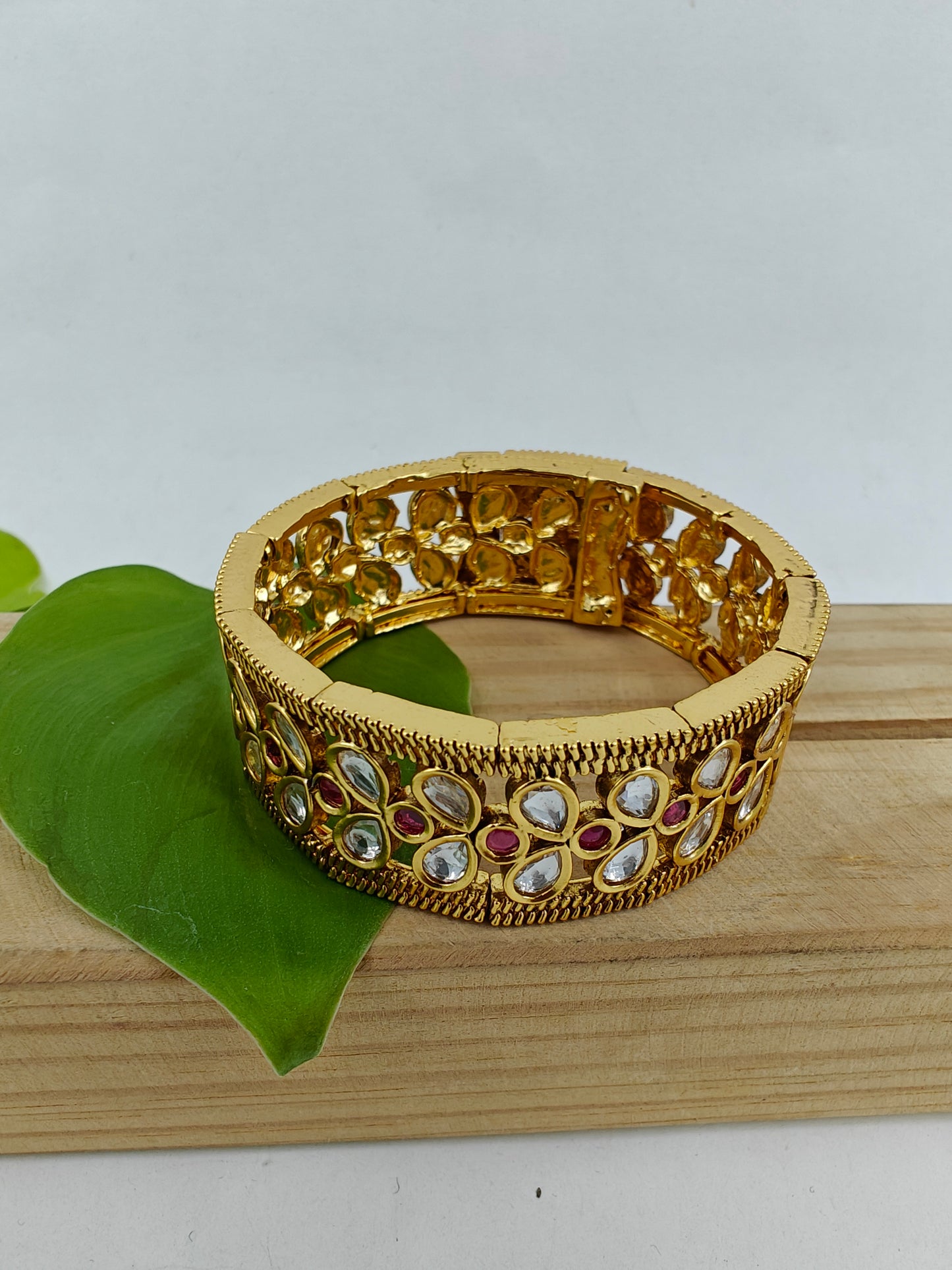 Gold finish kundan cuff with snap shut design