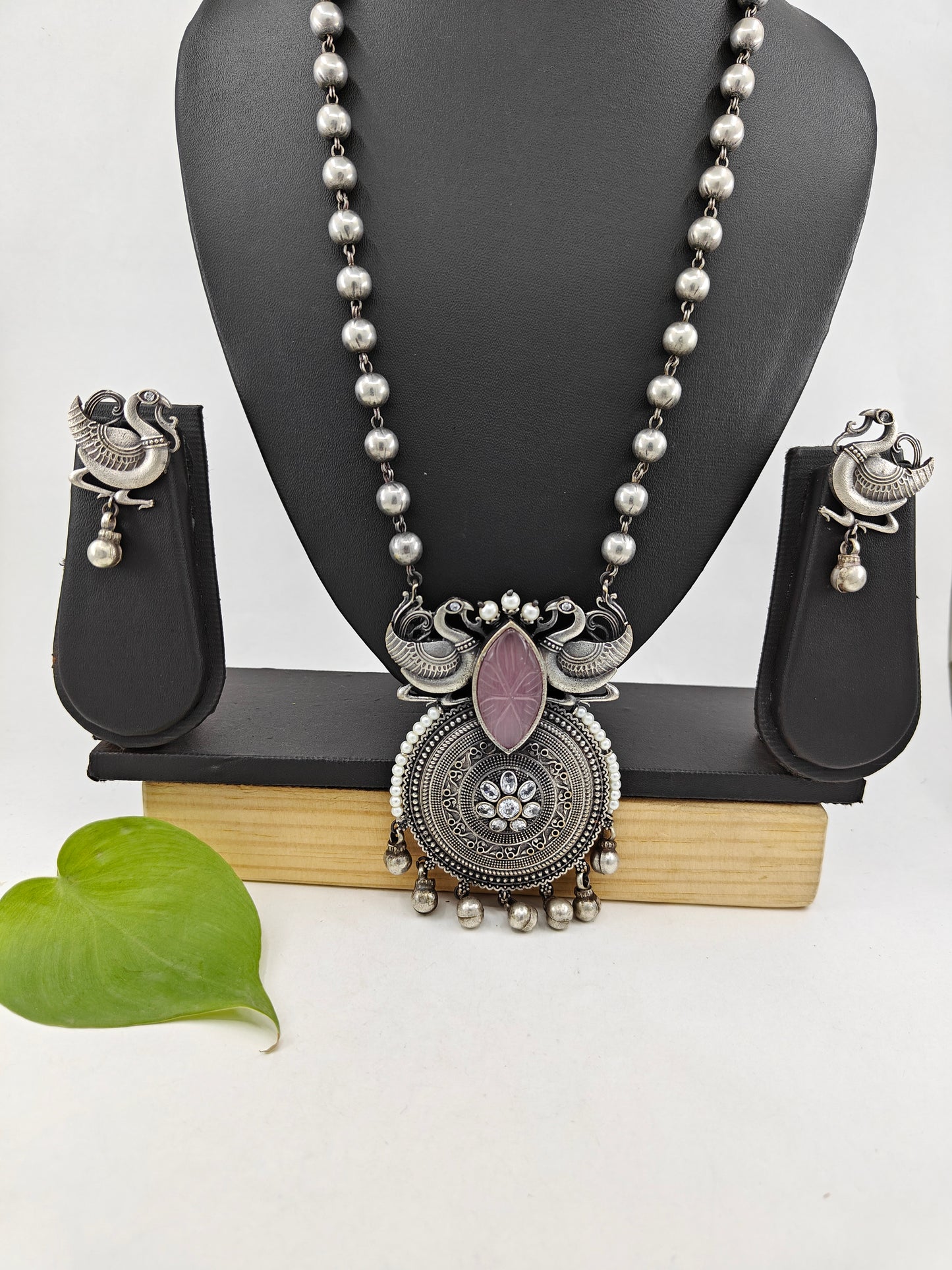 Set in antique silver finish with peacocks and a pink stone pendant on a bead chain