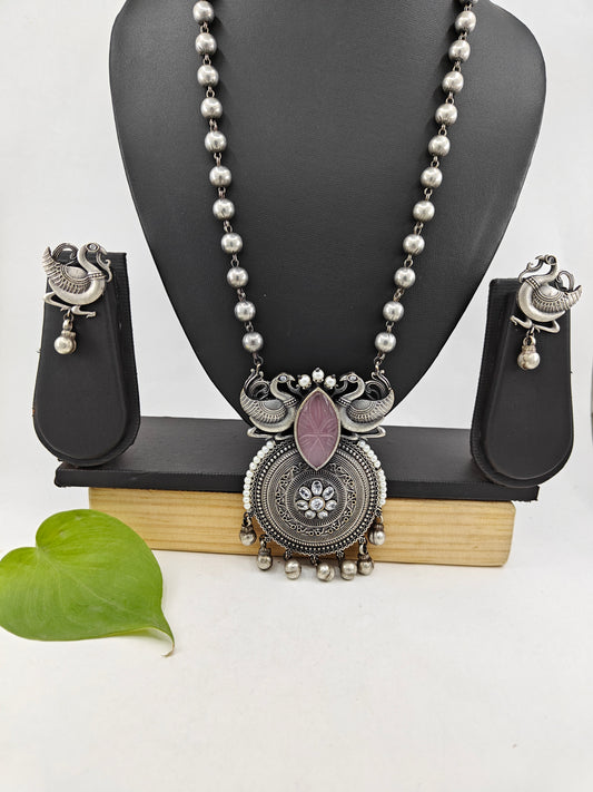 Set in antique silver finish with peacocks and a pink stone pendant on a bead chain