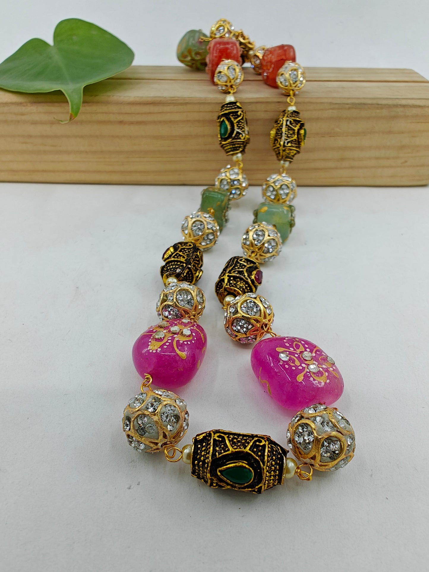 Bead necklace with pink green,orange worked upon beads and metal beads