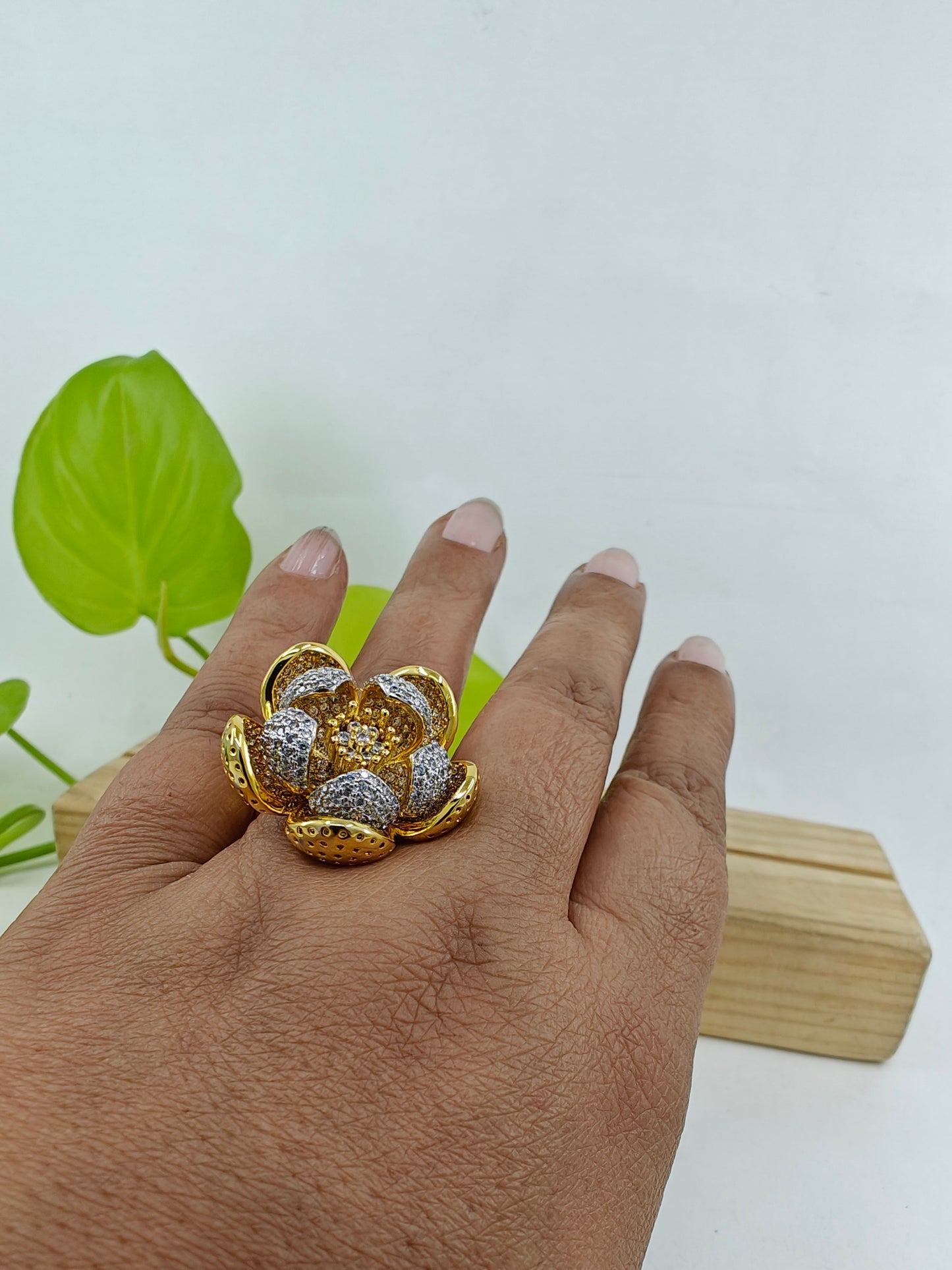 Dual tone ring with an open flower design with silver and gold finish petals