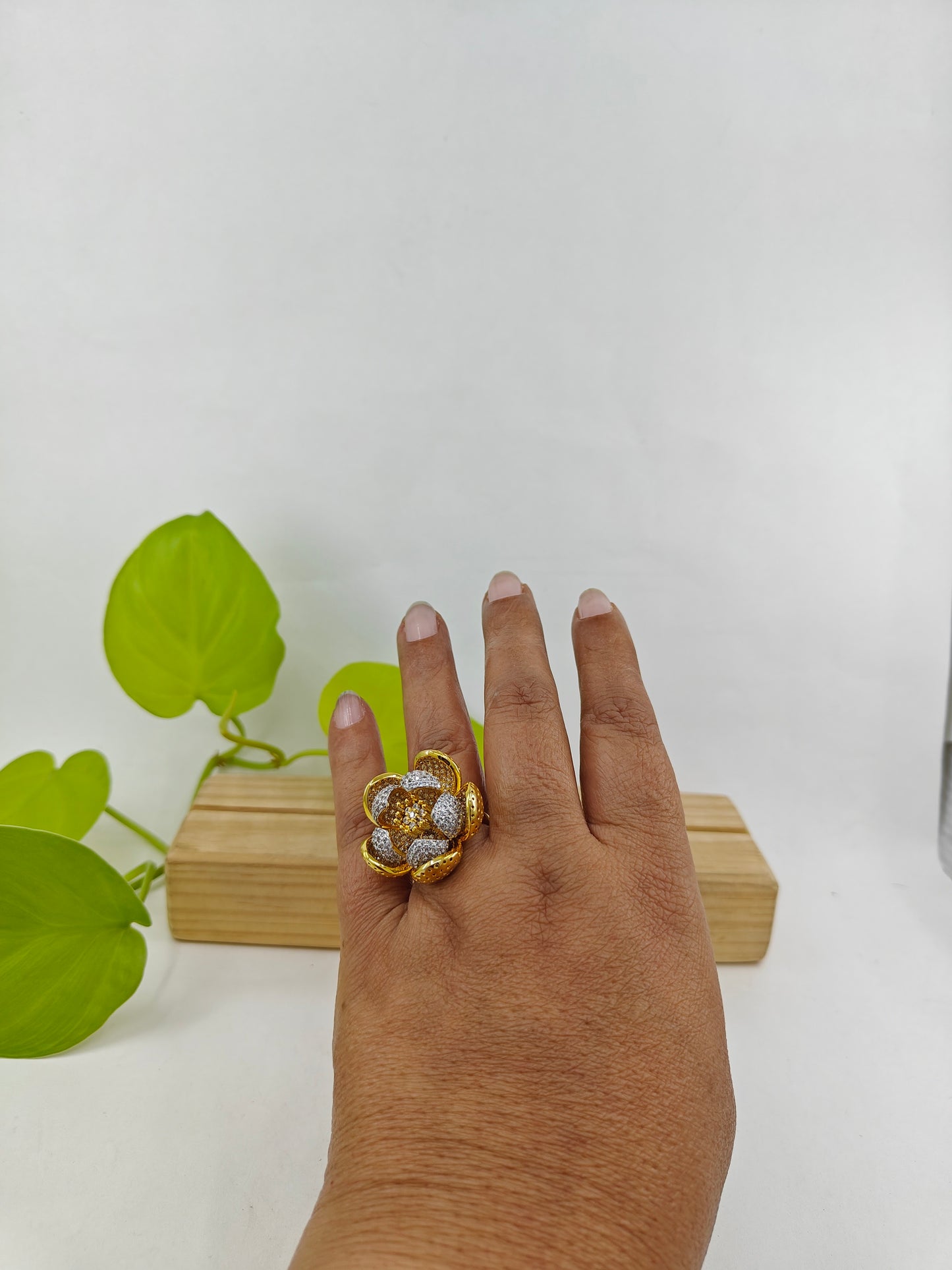 Dual tone ring with an open flower design with silver and gold finish petals