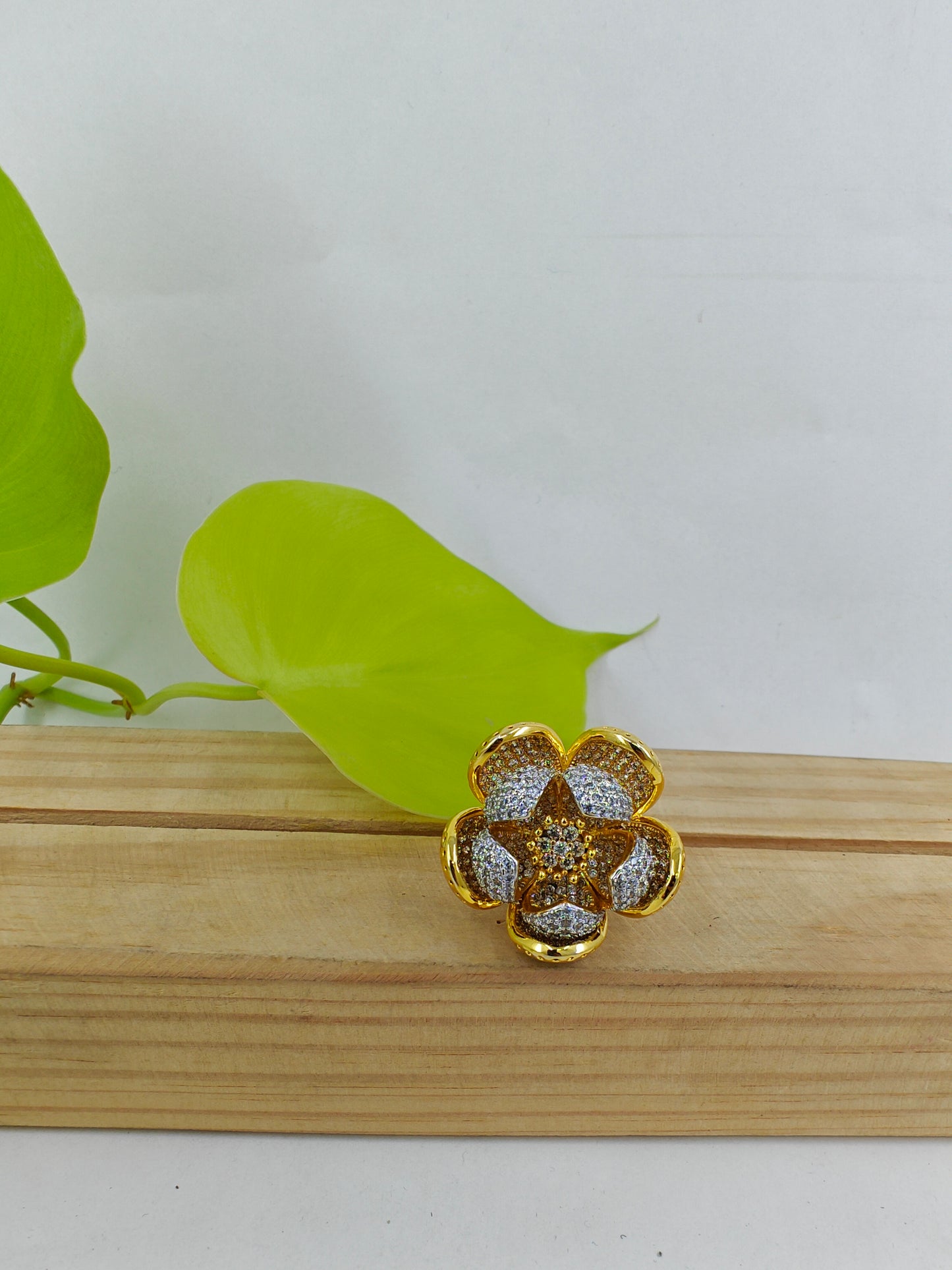 Dual tone ring with an open flower design with silver and gold finish petals