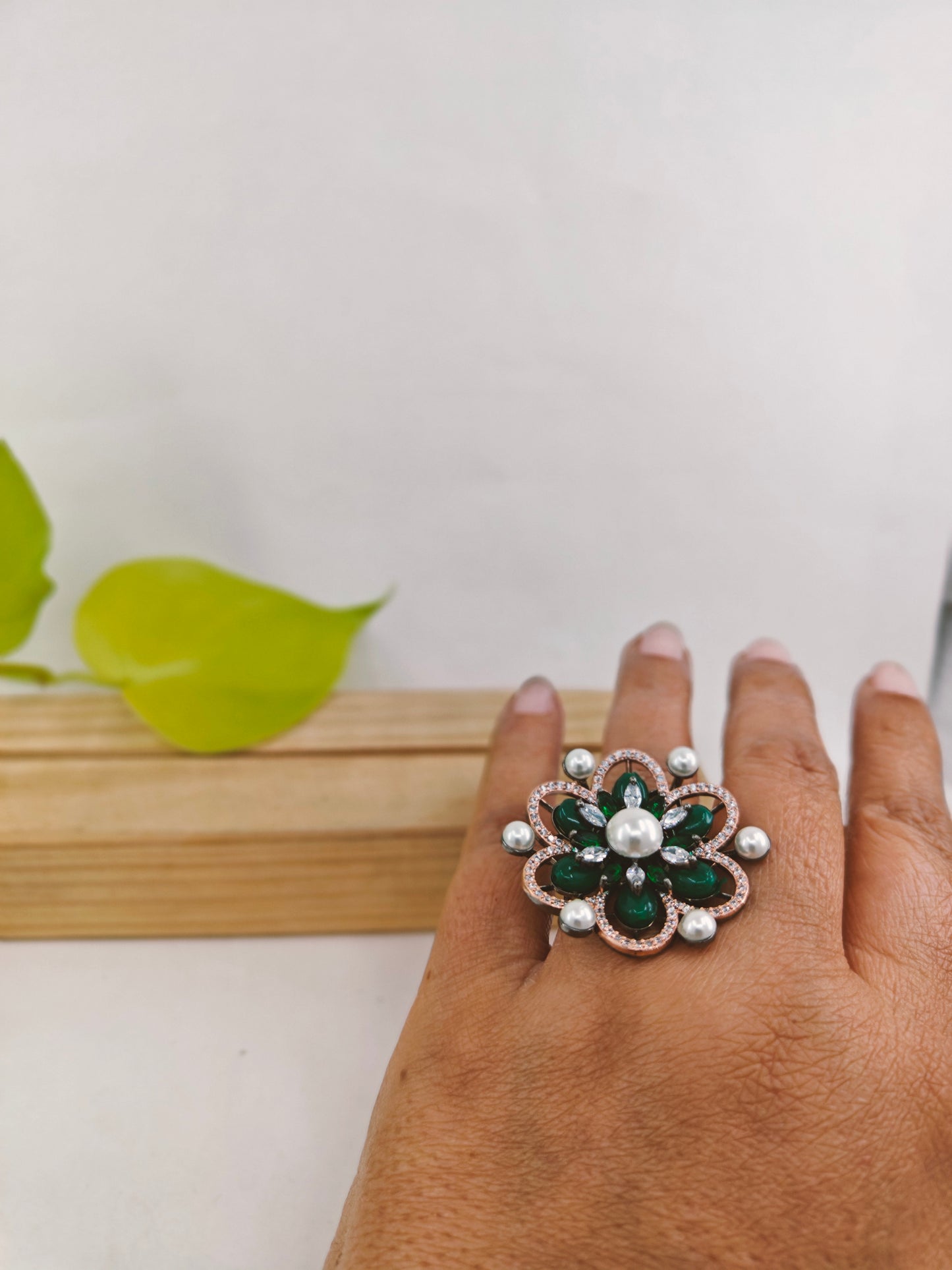 Antique platinum finish ring with emerald green stones,pearls and CZ