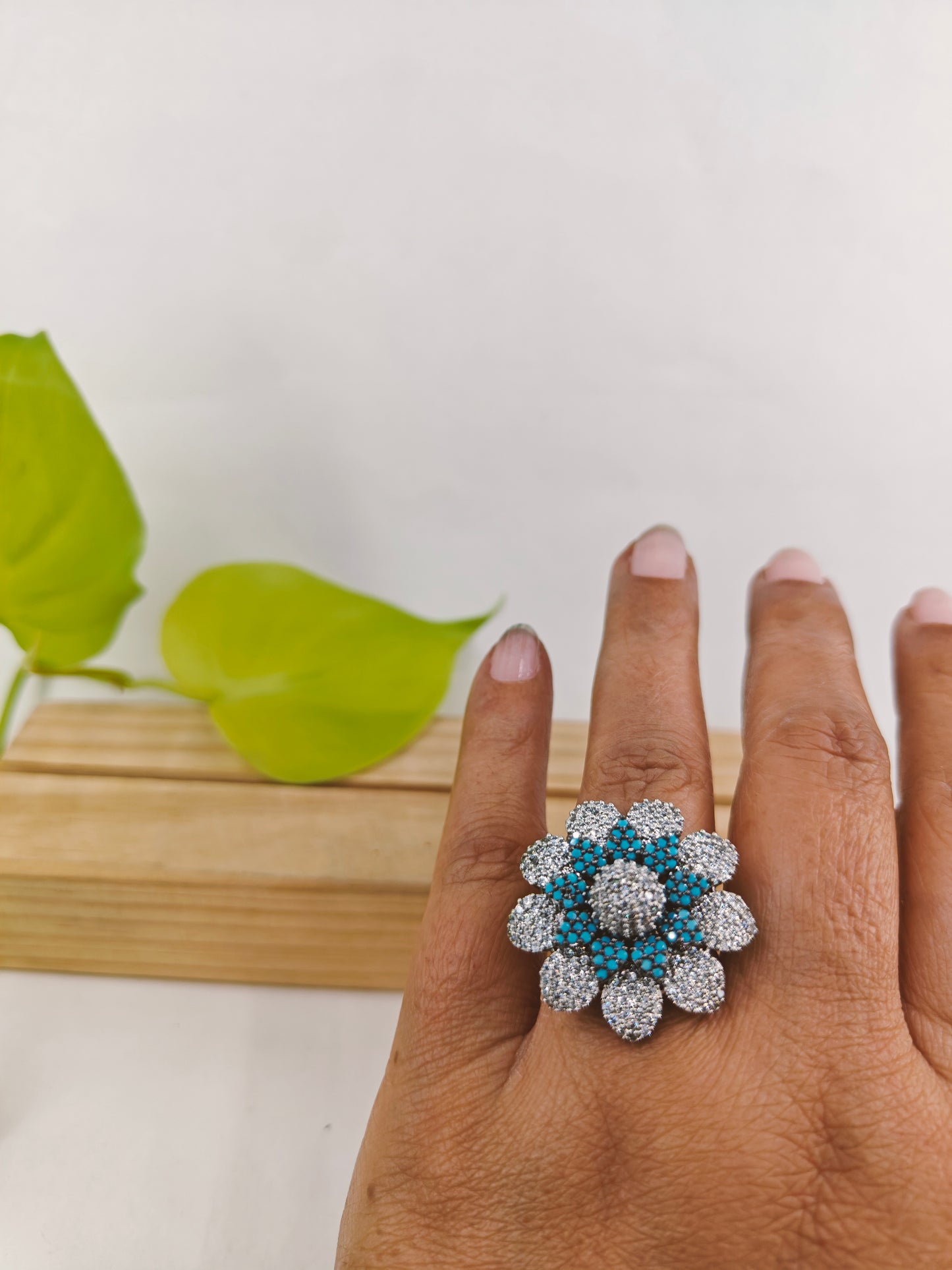 Ring in antique finish in a flower design with nano blue stones on Platinum CZ petals