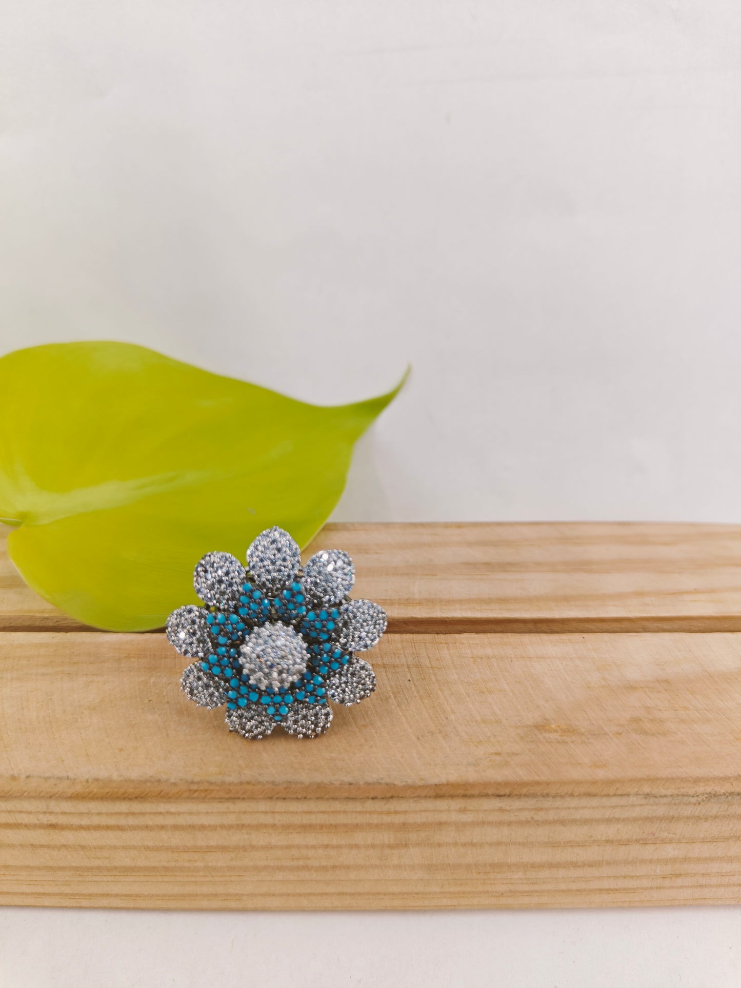 Ring in antique finish in a flower design with nano blue stones on Platinum CZ petals