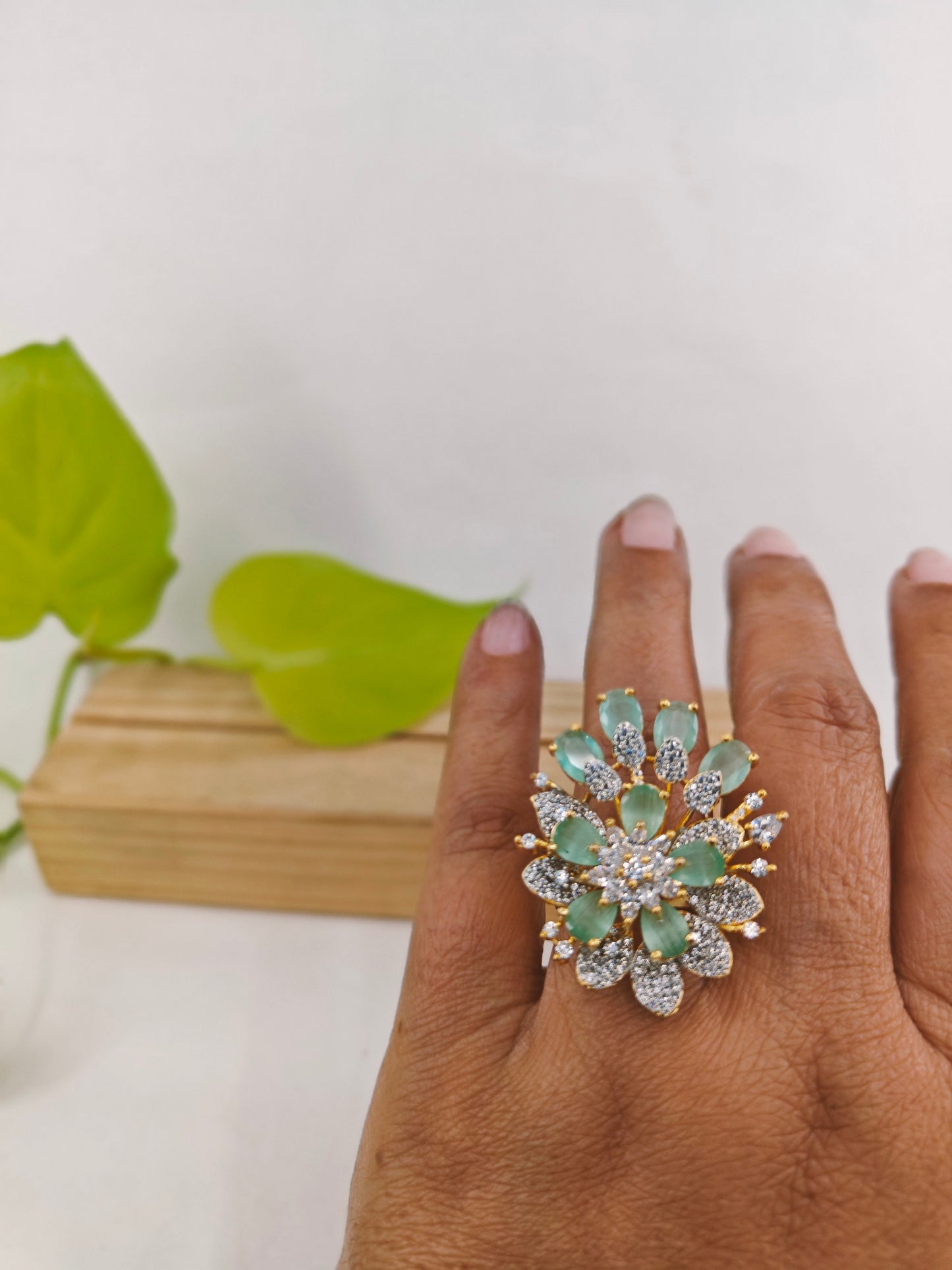 Gold finish ring with mint green and CZ flower design