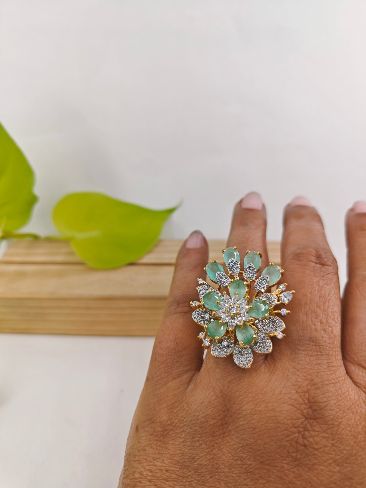 Gold finish ring with mint green and CZ flower design