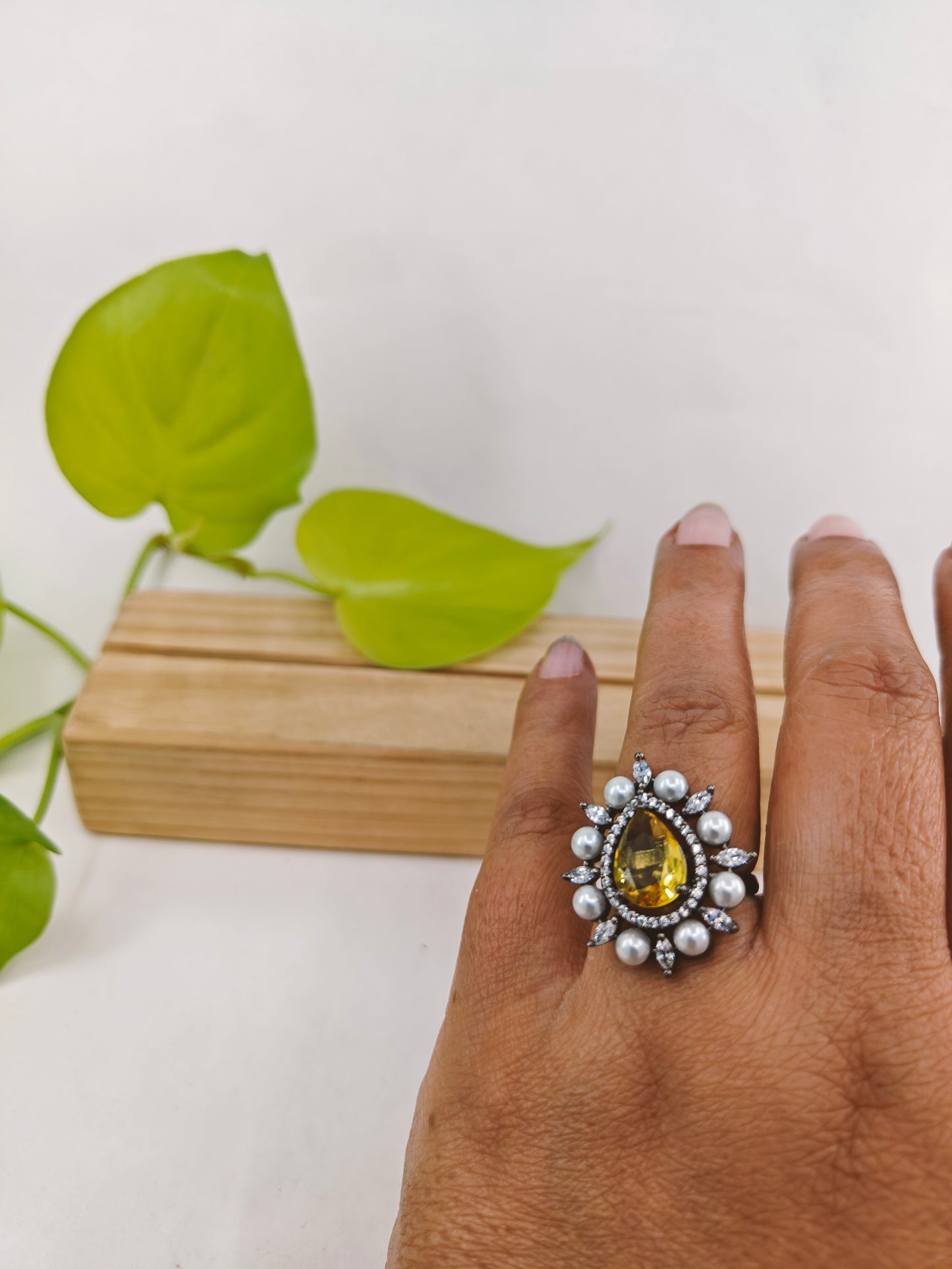 Antique platinum finish ring with teardrop yellow topaz surrounded with CZ and pearls