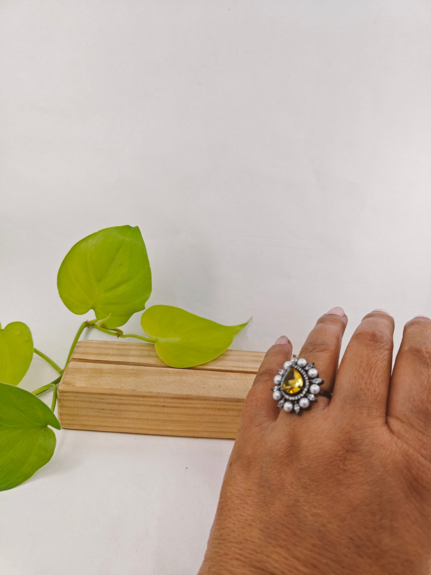 Antique platinum finish ring with teardrop yellow topaz surrounded with CZ and pearls