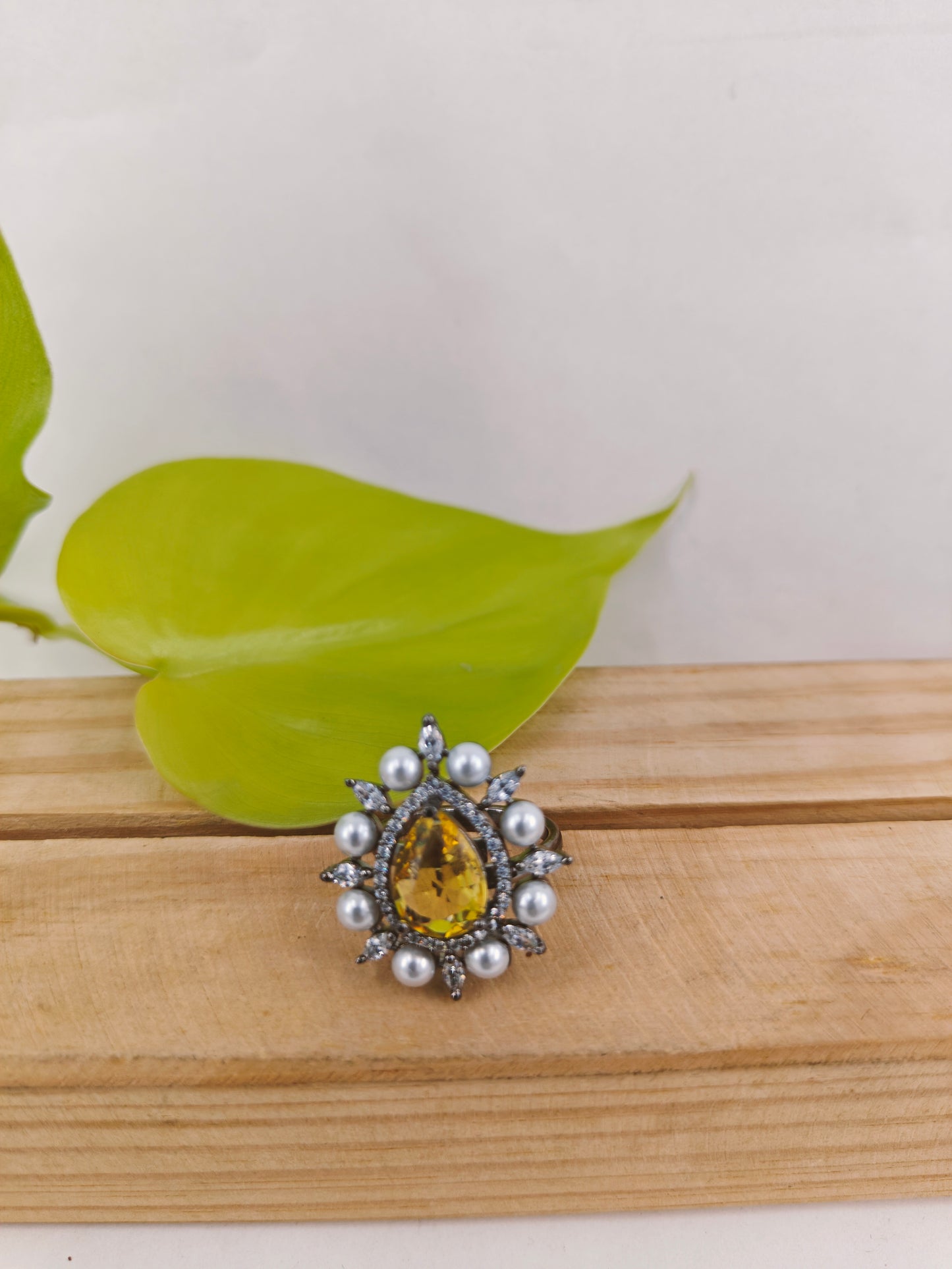 Antique platinum finish ring with teardrop yellow topaz surrounded with CZ and pearls