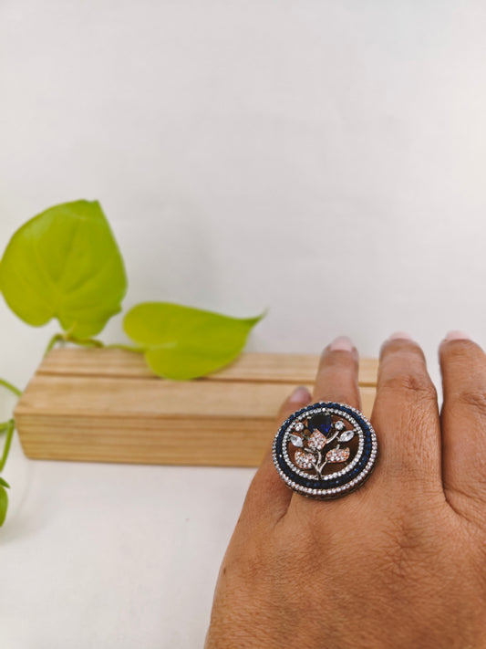 Platinum finish ring with sapphire flower with CZ leaves