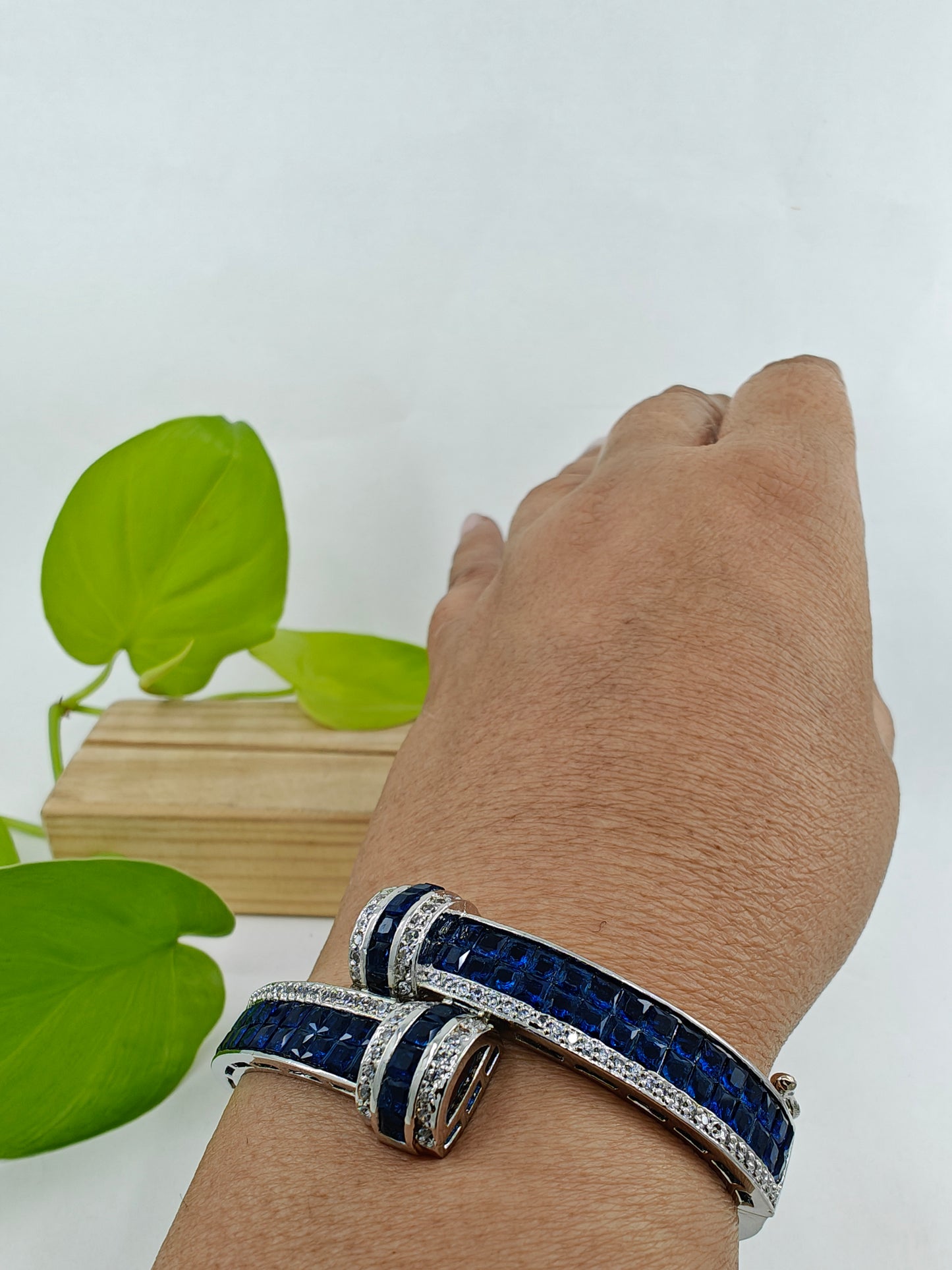 Kara/ bracelet in platinum finish with blue sapphire stones and CZ