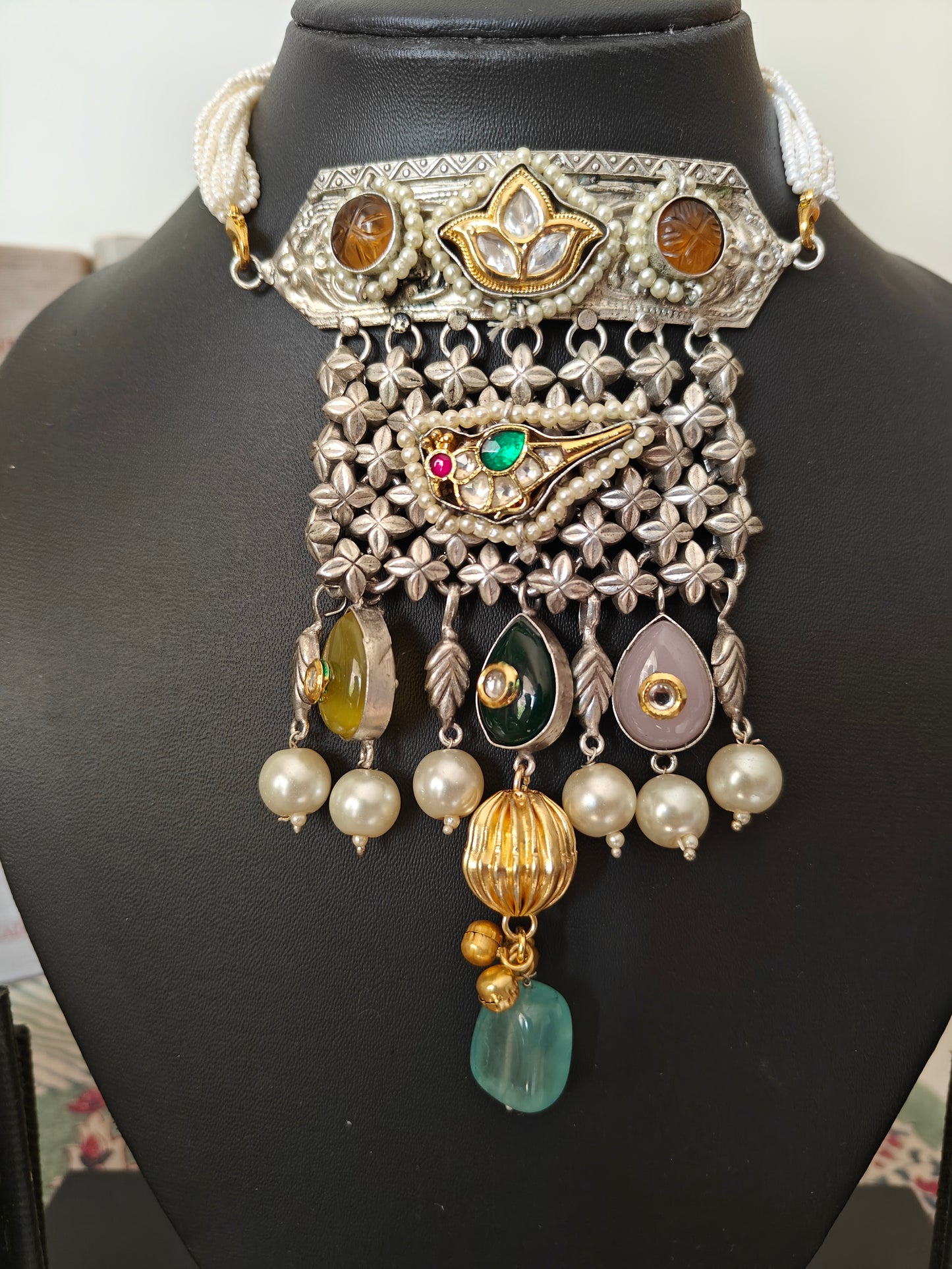 Necklace in dual tone with pendant with chattai work, pearched peacock with pearls,kundan and big stone hangings on poth pearls strings