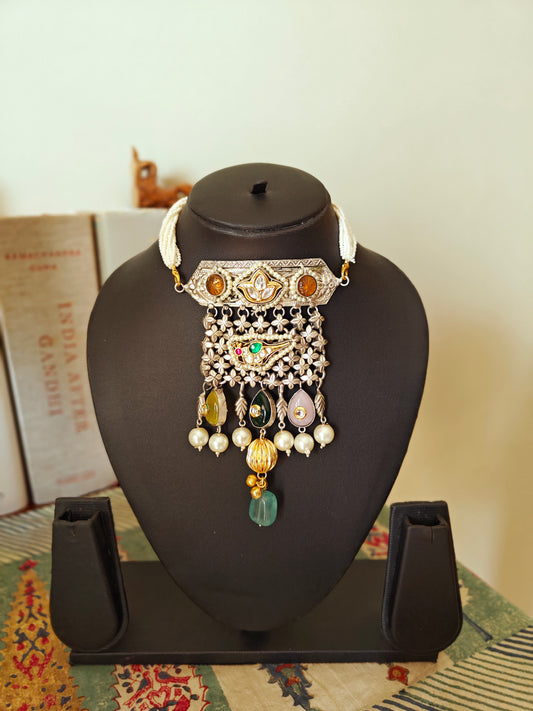 Necklace in dual tone with pendant with chattai work, pearched peacock with pearls,kundan and big stone hangings on poth pearls strings