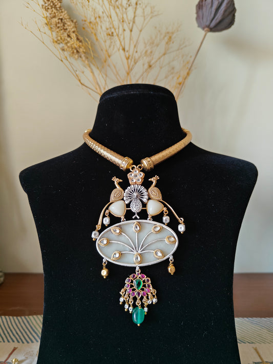 Hasli set in dual tone, pearched peacocks on stone pendant with Kundan work, matching earrings