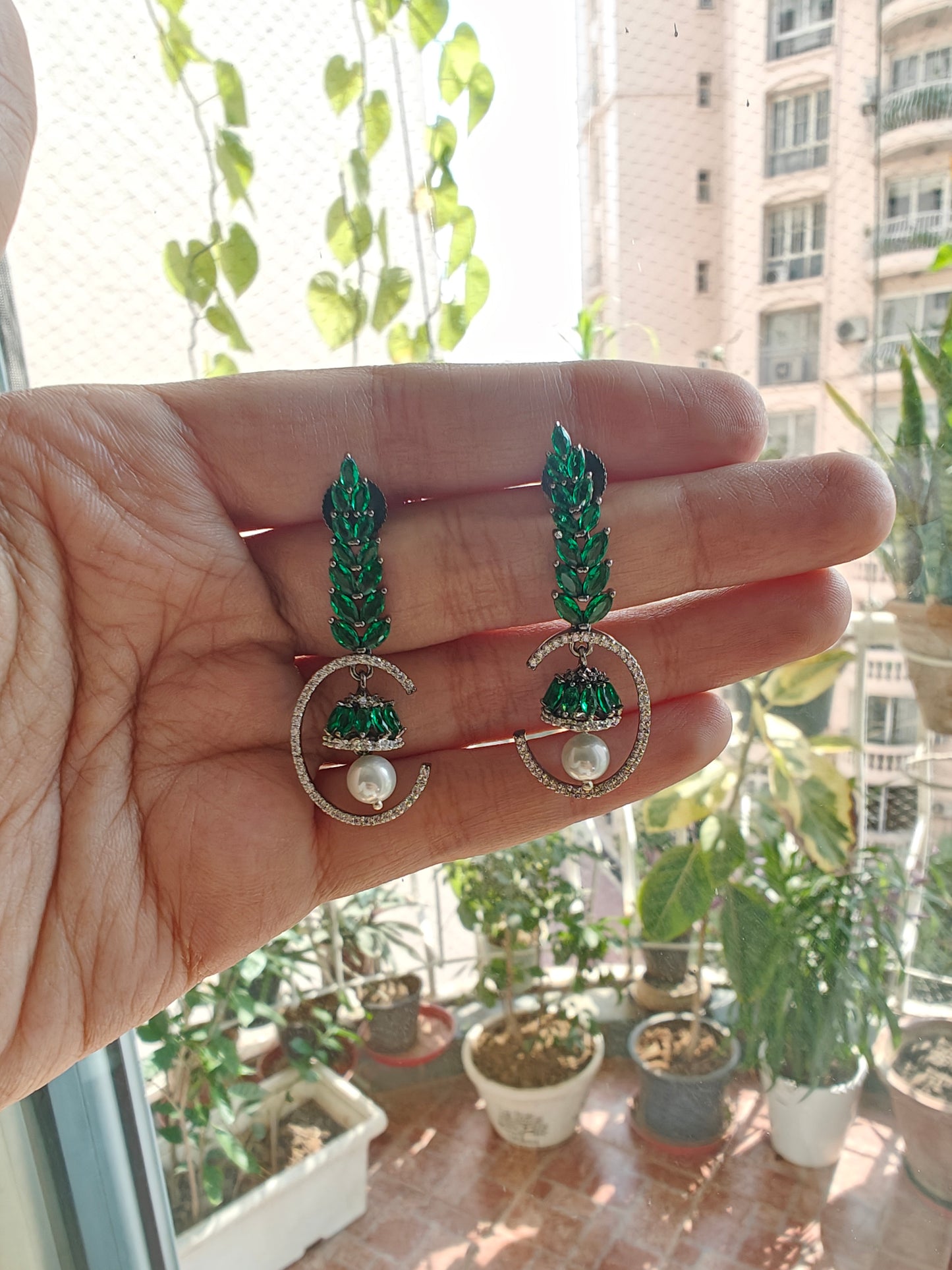 Leaf green twig earrings with a bell hanging