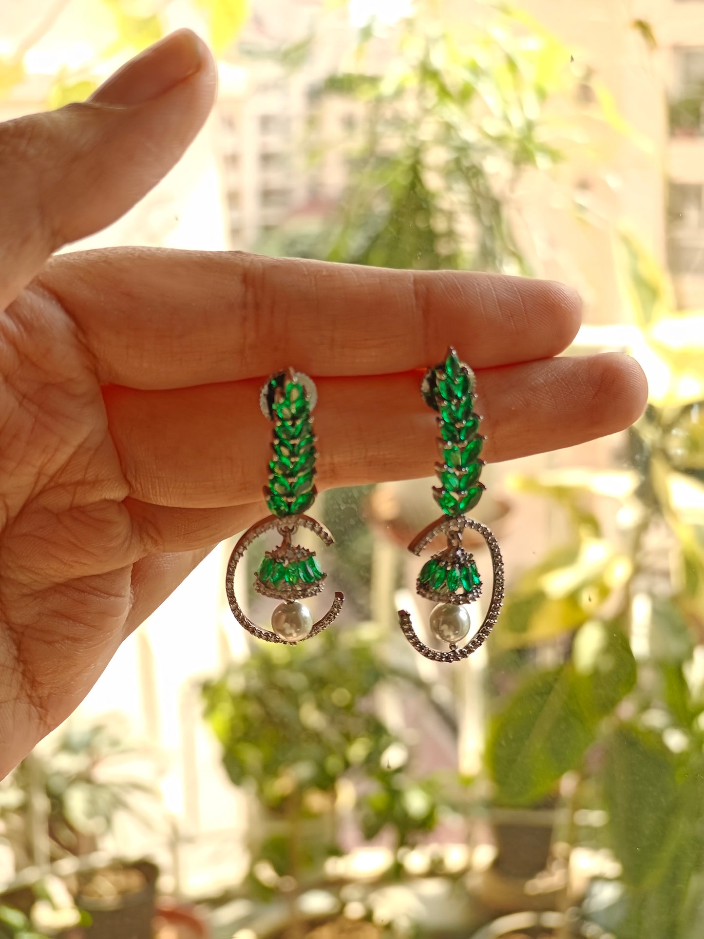 Leaf green twig earrings with a bell hanging