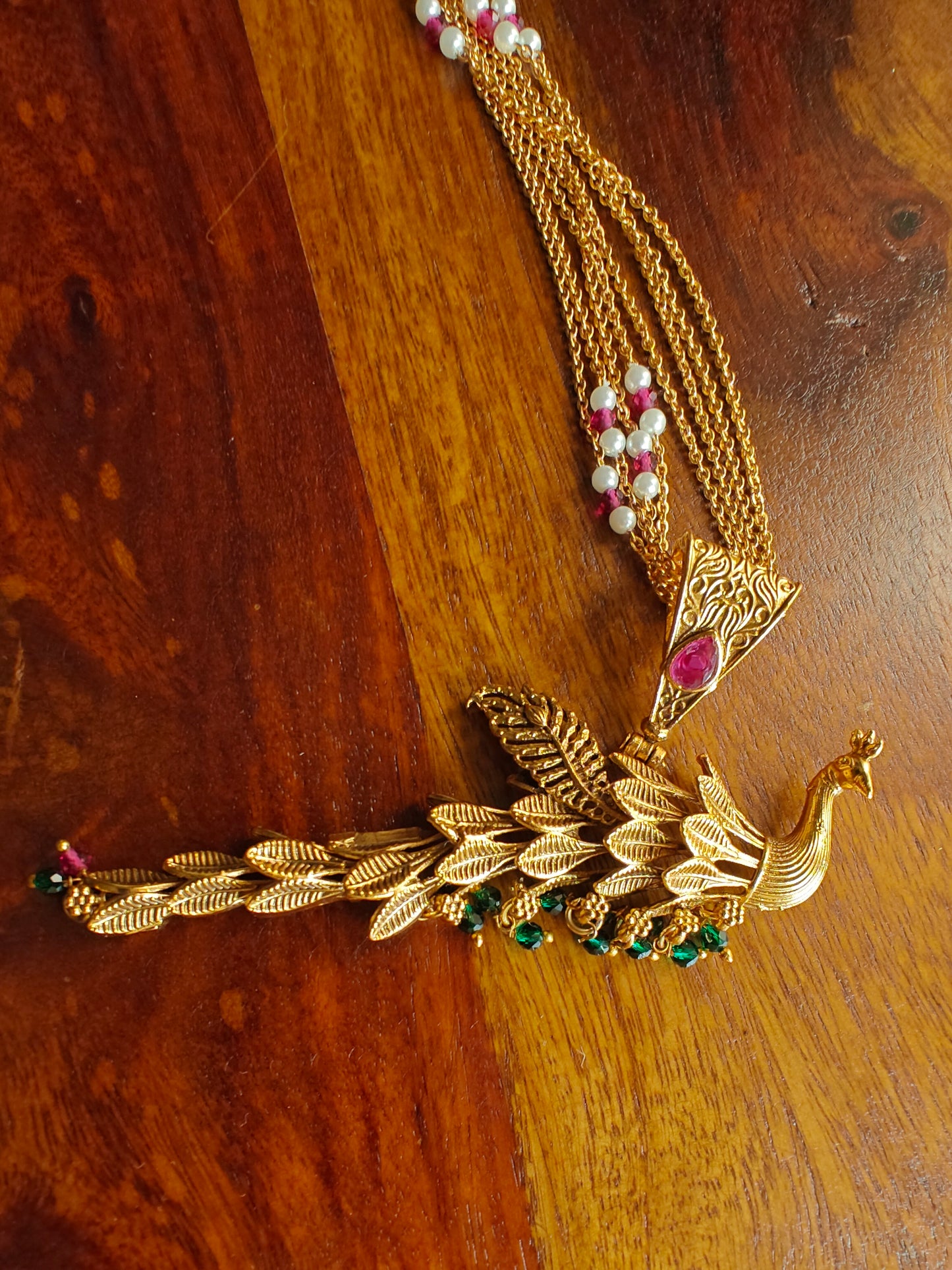 Dancing peacock pendant on golden strings