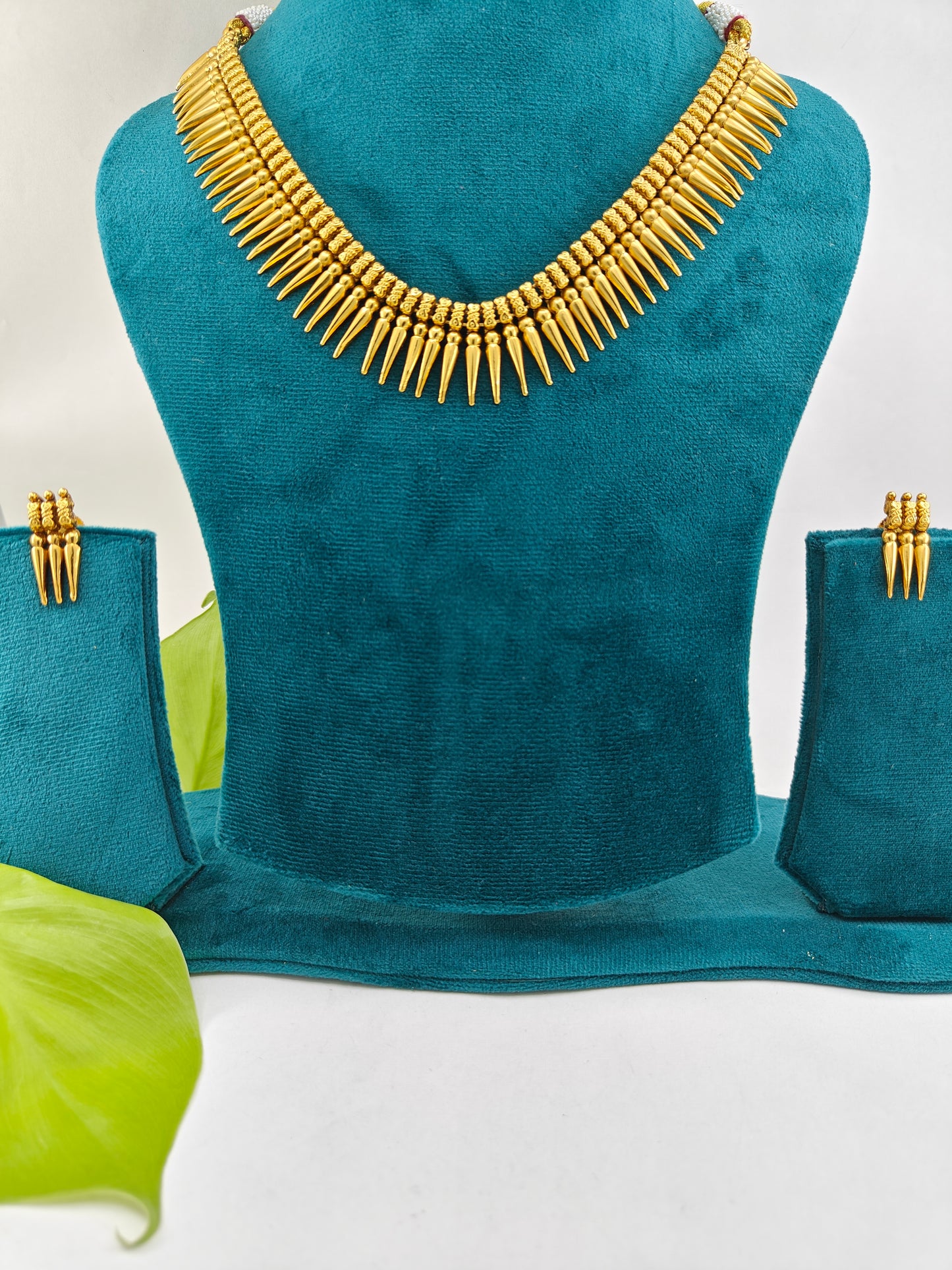 Gold finish set with spikes on the necklace and matching studs