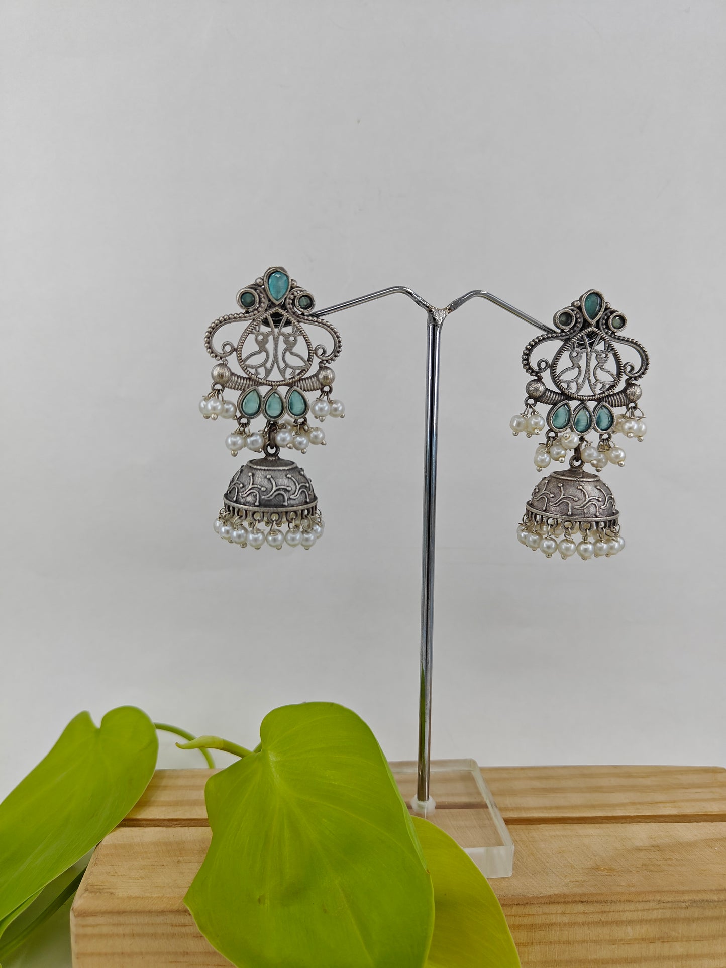 Earrings( jhumkis) with mint green stone highlights