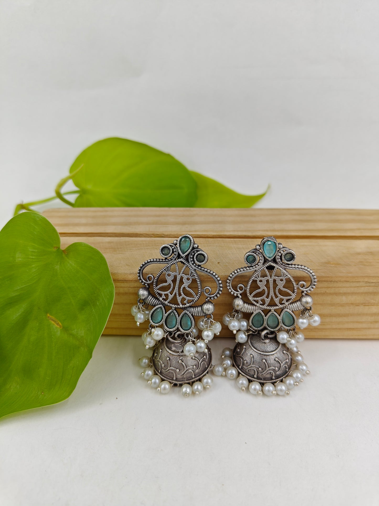 Earrings( jhumkis) with mint green stone highlights